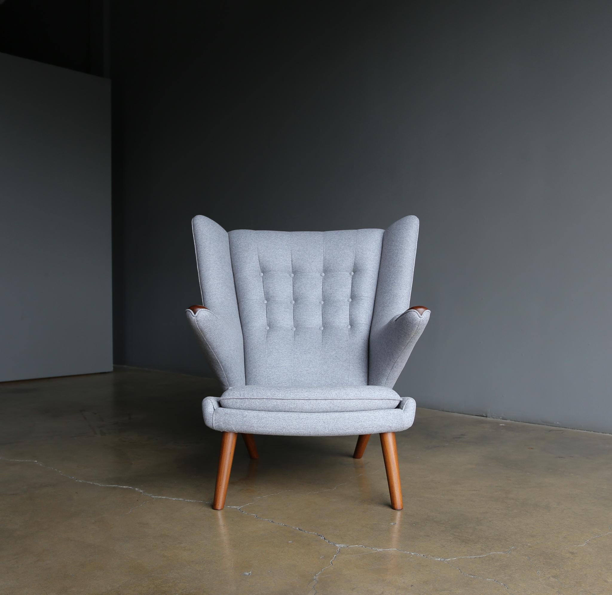 Hans Wegner AP-19 papa bear chair for A.P. Stolen, Denmark, circa 1952. This piece has been expertly restored in Andrew Martin grey wool upholstery. Retains the original Danish Control Medallion to the bottom.