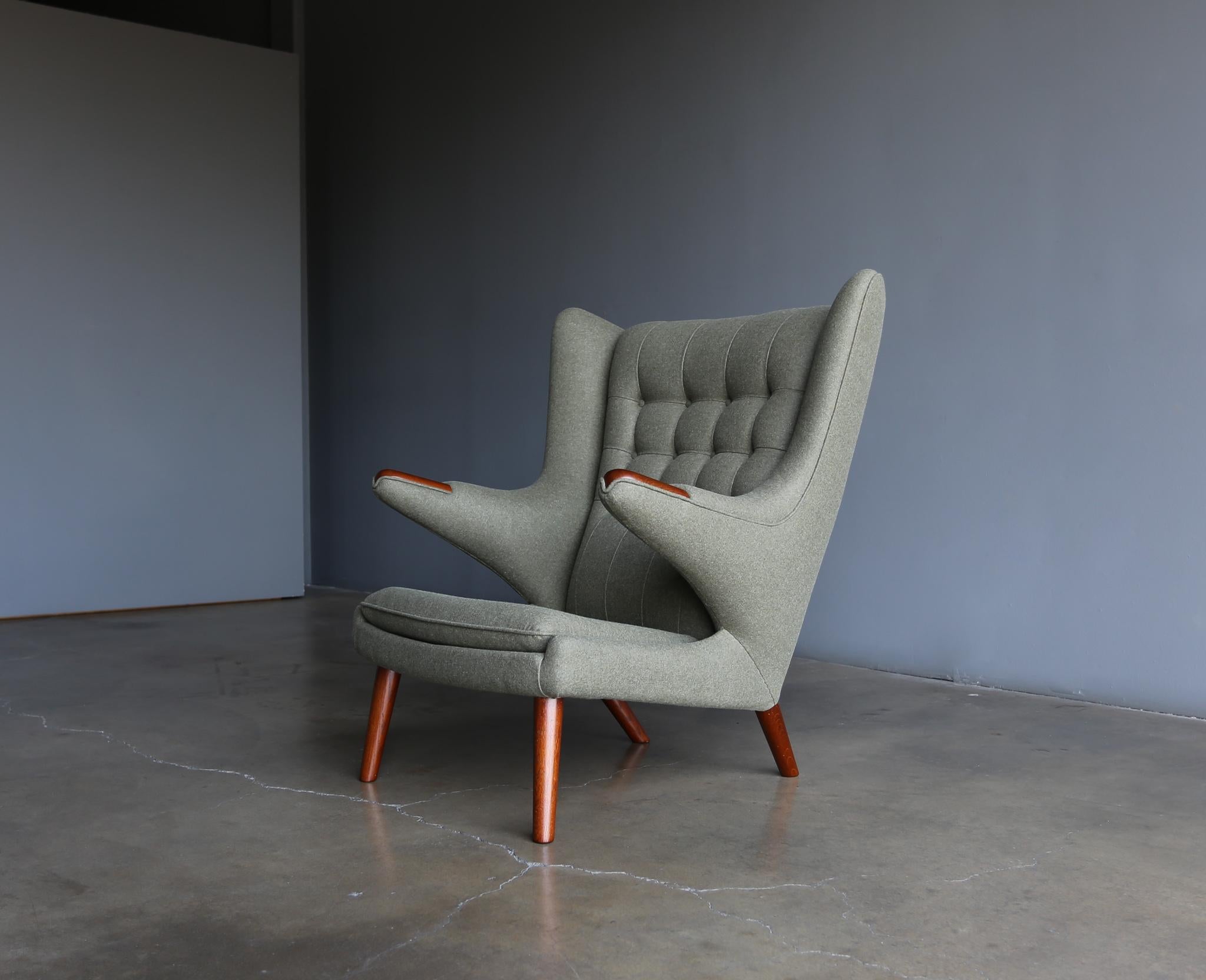 Hans Wegner AP-19 papa bear chair for A.P. Stolen, Denmark, circa 1952. This piece has been expertly restored in Kravet Couture green wool upholstery. A.P. Stolen Makers stamp to the bottom.