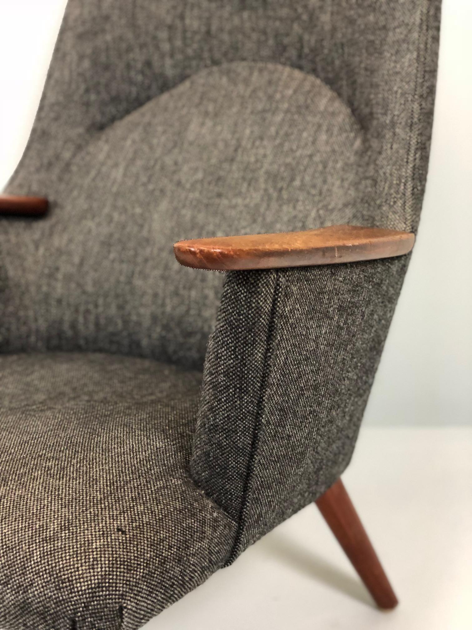 Hans Wegner AP-27 lounge chair designed in 1954 and produced by A. P. Stolen.
This sculptural high back armchair is very comfortable and is in original Vintage condition. Teak arm pads and legs. It has an additional headrest.