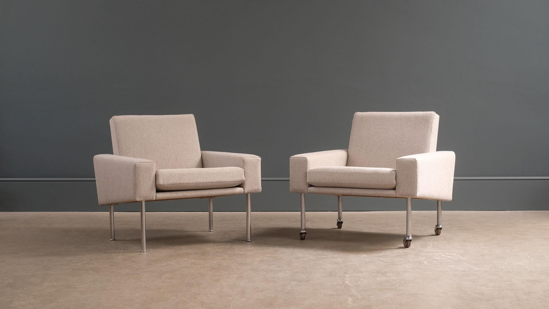Fantastic pair of model AP34 armchairs designed by Hans Wegner for cabinetmaker A P Stolen, Denmark. Great looking and comfortable chairs fully reconditioned and reupholstered in Fleck fabric. Original configuration including one chair on wheels.