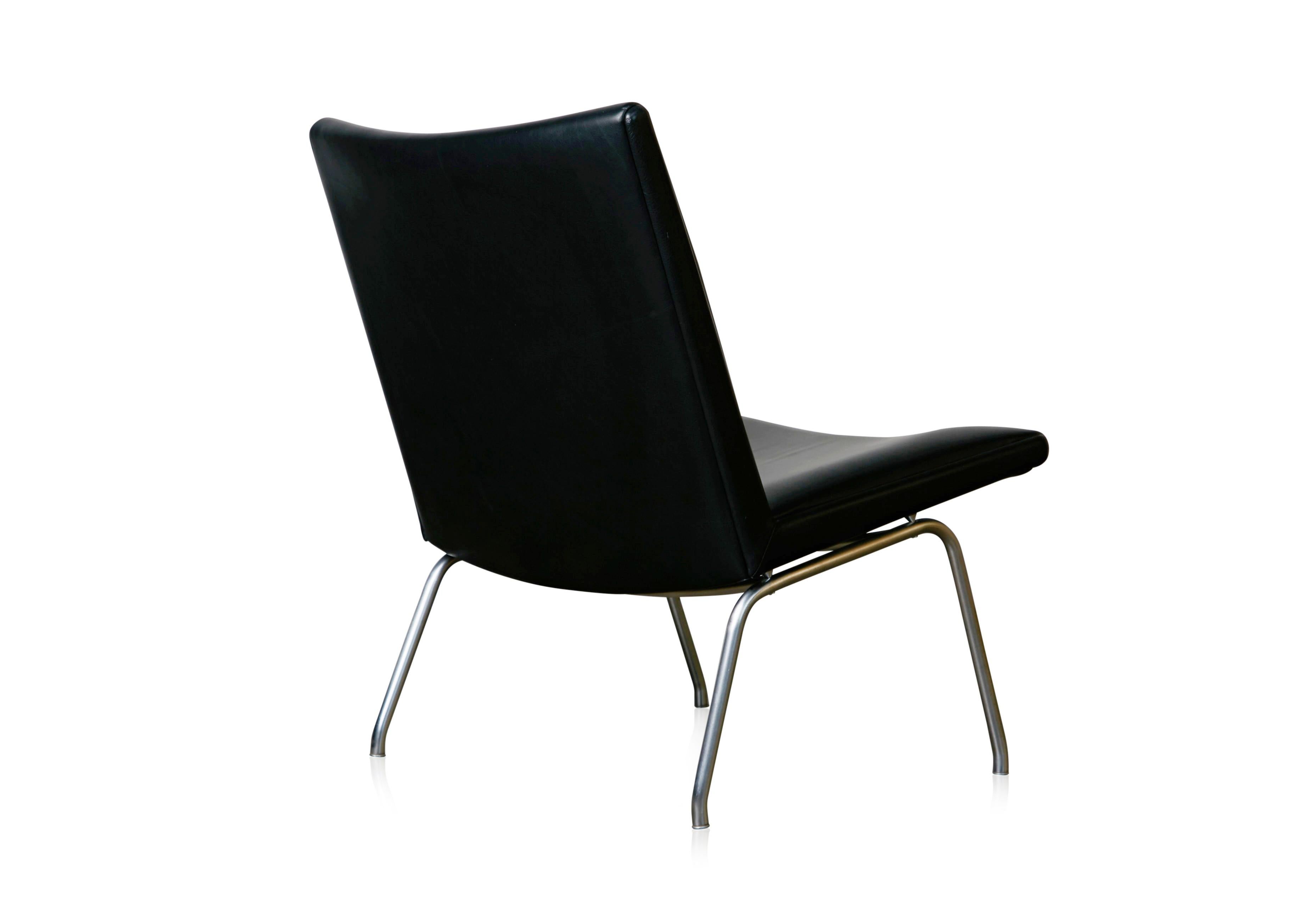 A classic design by Hans Wener for the Kastrup Airport in Copenhagen and produced by A.P. Stolen, this easy chair is covered in black leather sitting upon chrome plated steel frame. 

Another similar model, the AP-40, has steel side rails whereas