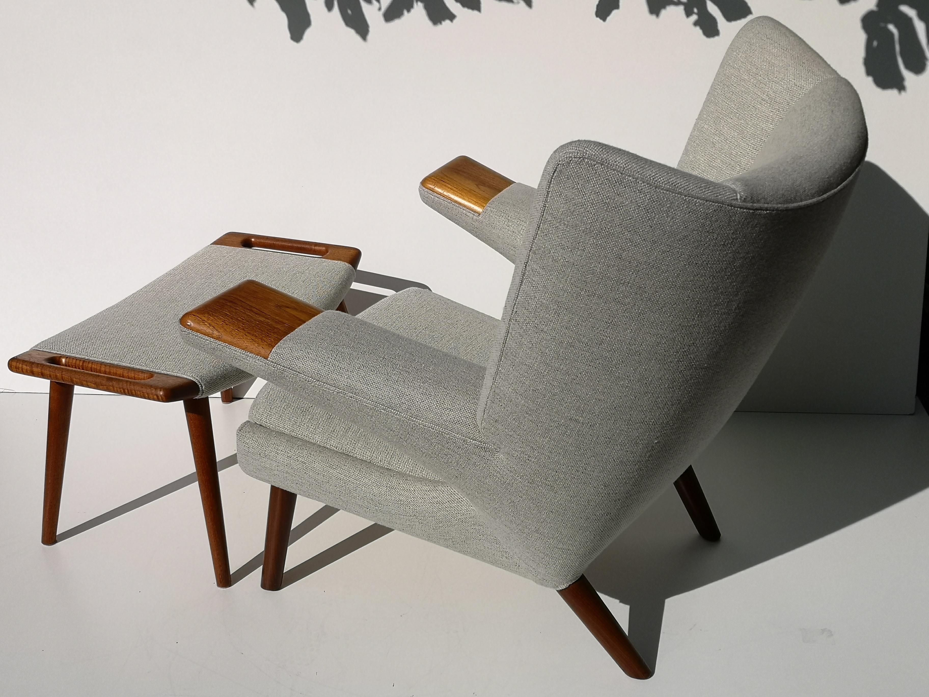 Hans Wegner's special edition of the traditional papa bear chair, the AP69 mega bear chair is fantastically rare. This particular model is even more uncommon, with teak paws and legs. Matched nicely with a teak foot stool, both pieces are freshly