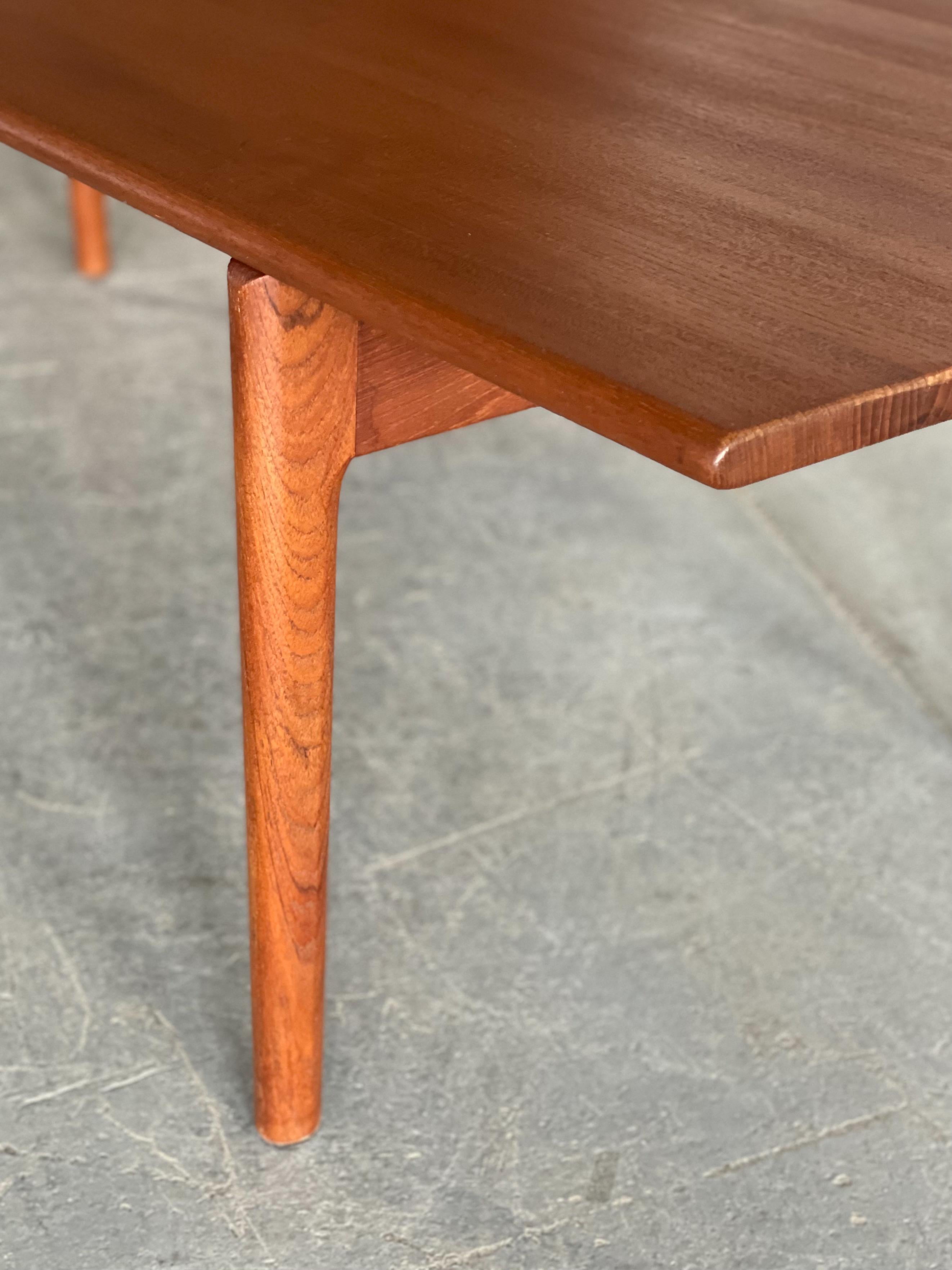 Stunning solid teak Model AT-15 coffee table designed by Hans Wegner for Andreas Tuck, Denmark. This piece features solid plank construction, nicely sculpted legs, and contoured edge detail. Measures 71” W x 23” W x 19” H. Nice condition.