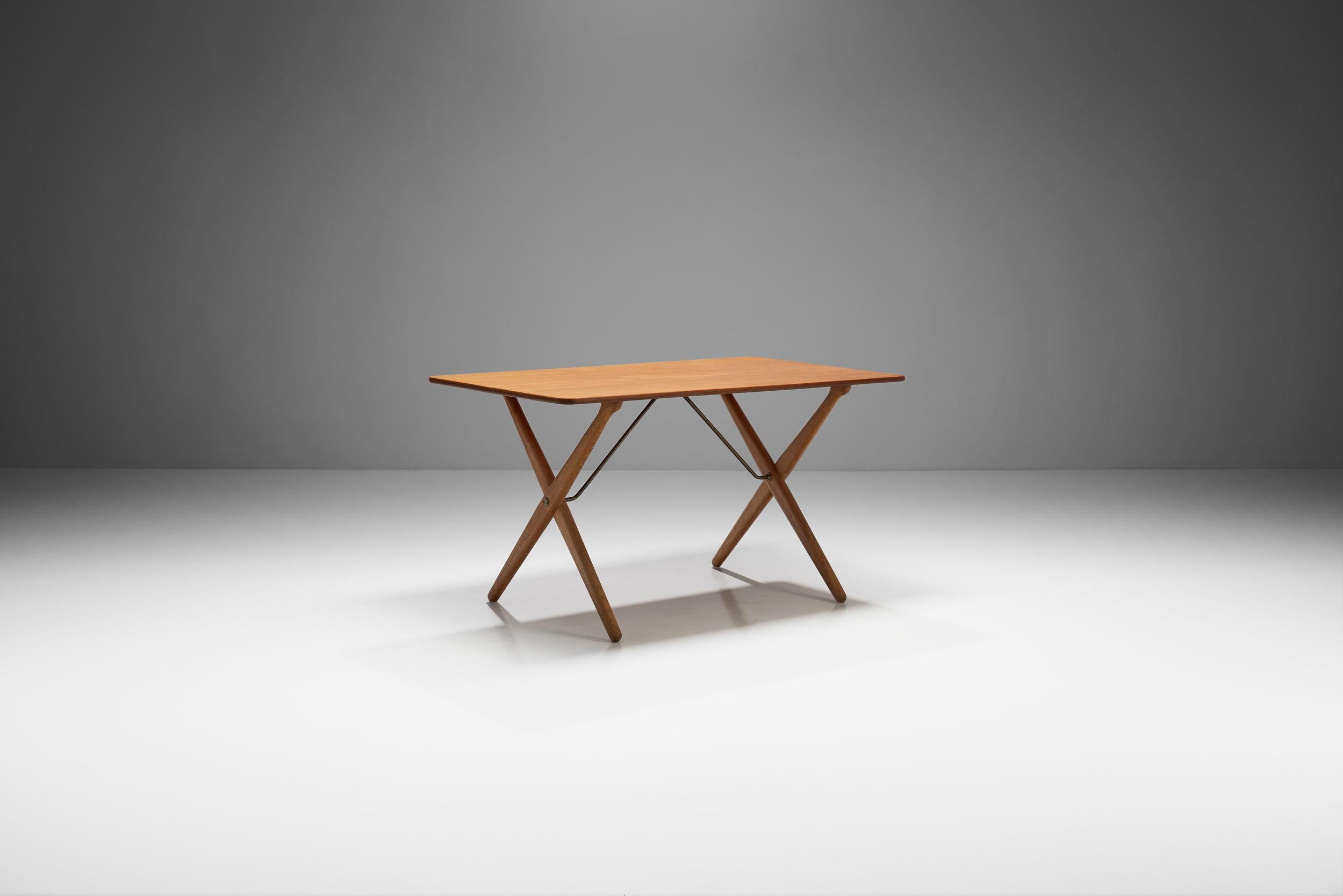 Hans Wegner 'AT 308' oak coffee table with cross-leg frame, Denmark 1950s. Manufactured and marked by Andreas Tuck, Odense. This coffee table has a grain that has come out beautifully over time, the slender cross legs are strengthened by thin metal