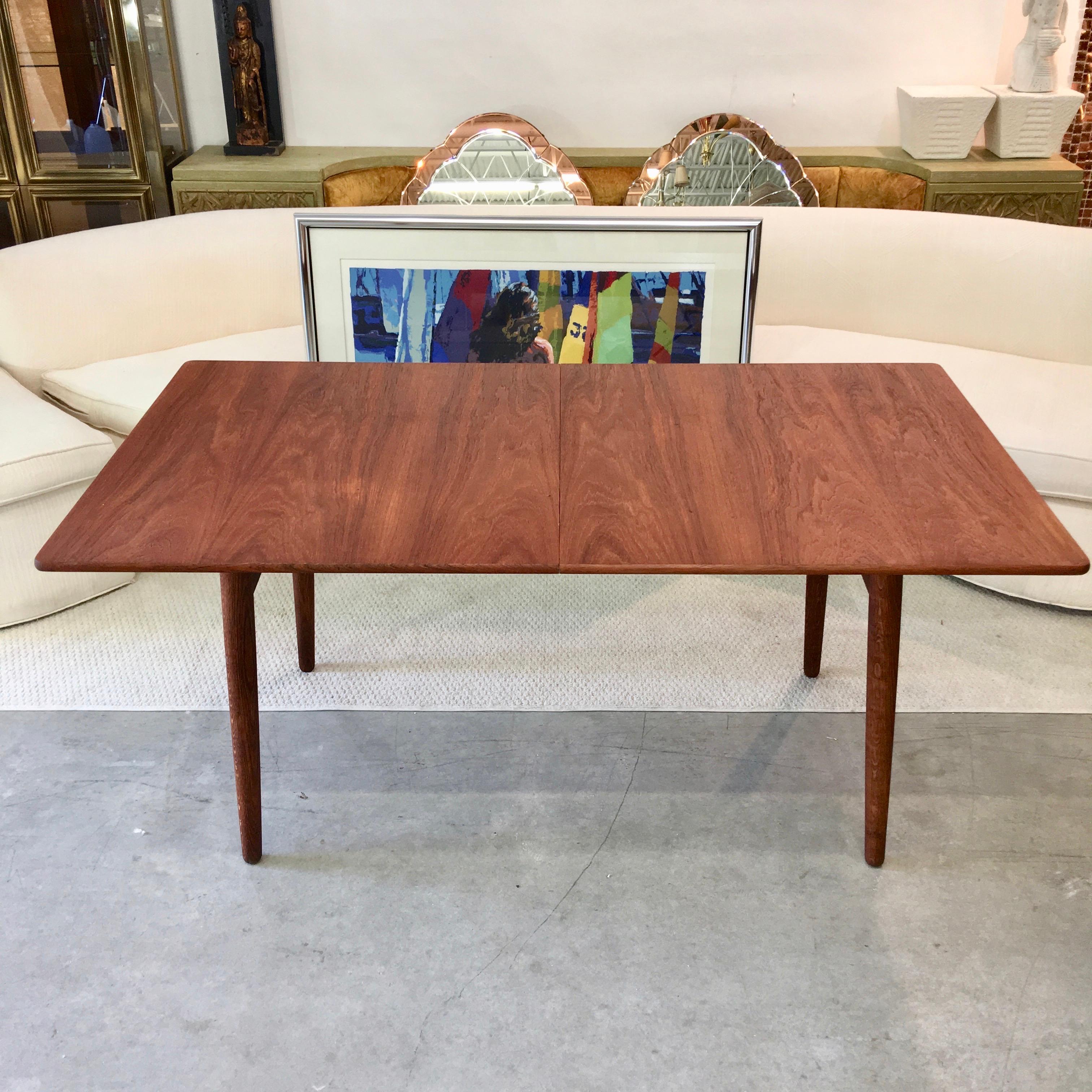 Model AT310 dining table by Hans J. Wegner (1914-2007) for Andreas Tuck, Denmark. Oil rubbed teak top with two 16