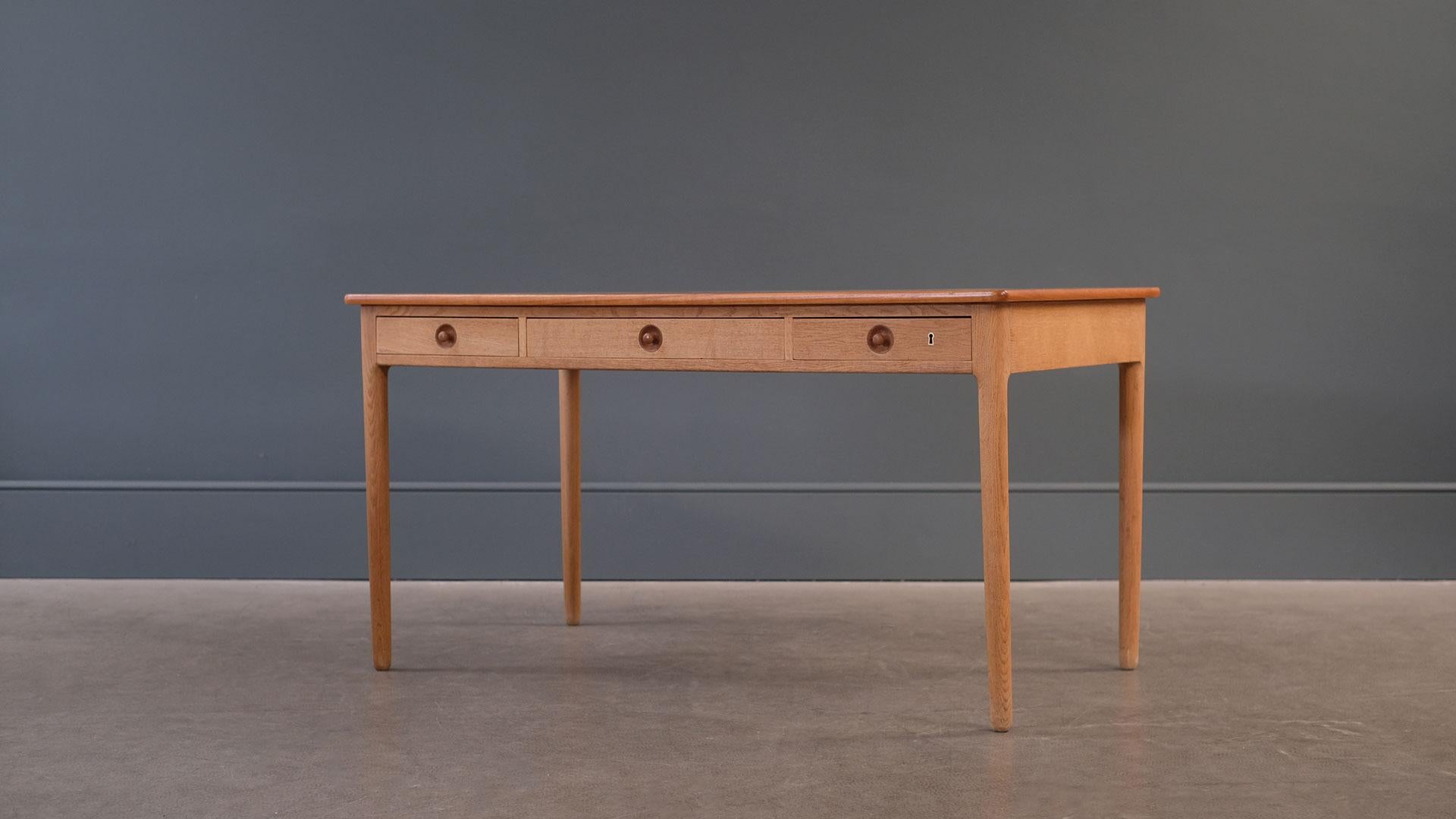 Beautiful desk with oak frame and contrasting teak top designed by Hans Wegner for cabinet maker Andreas Tuck, Denmark.