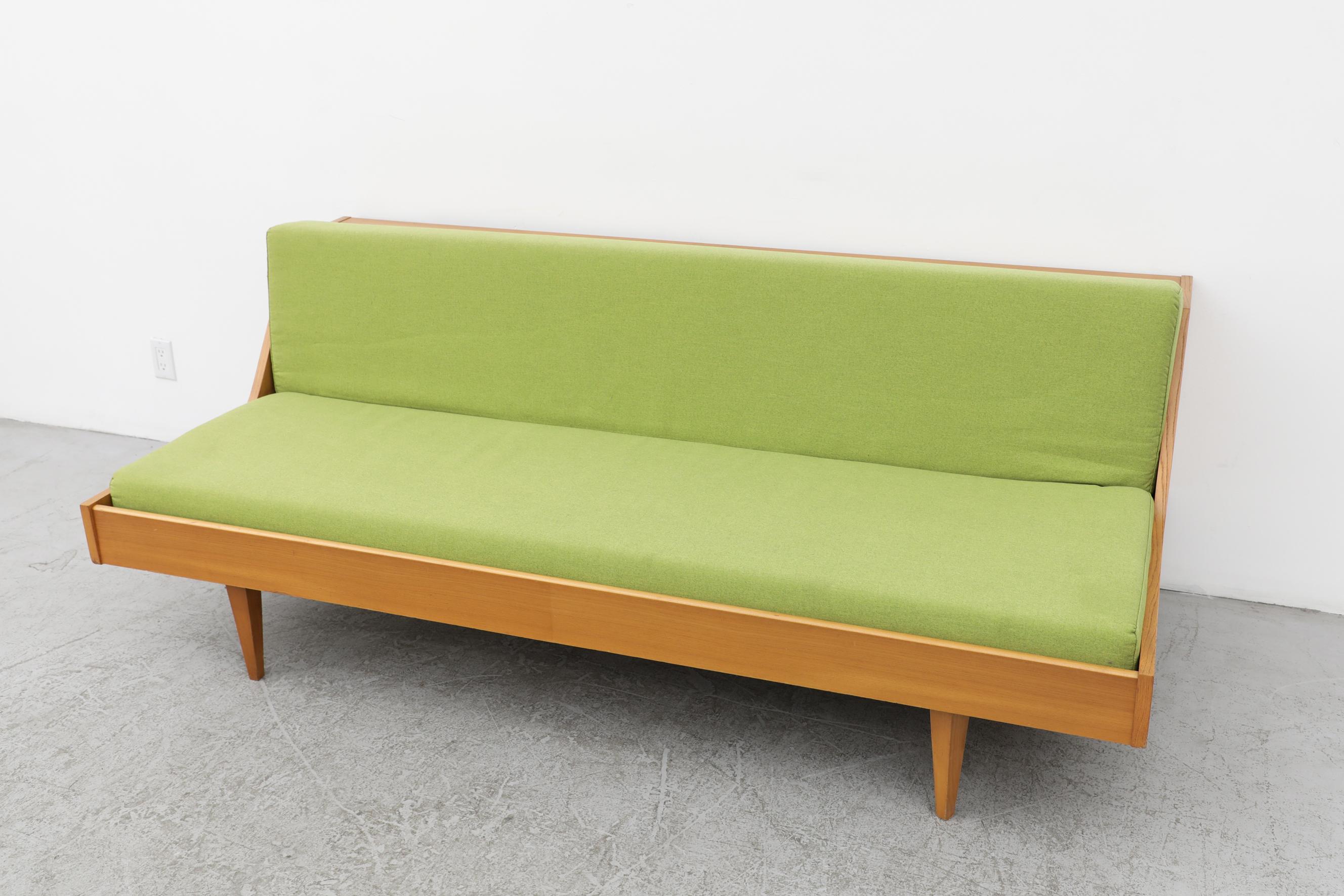 Hans Wegner attributed Model GE 258 for Getama sleeper sofa with kiwi green upholstery. The backrest can be raised, giving you added storage space for pillows and blankets, but it can also turns into a sleeper sofa. The backboard has some interior