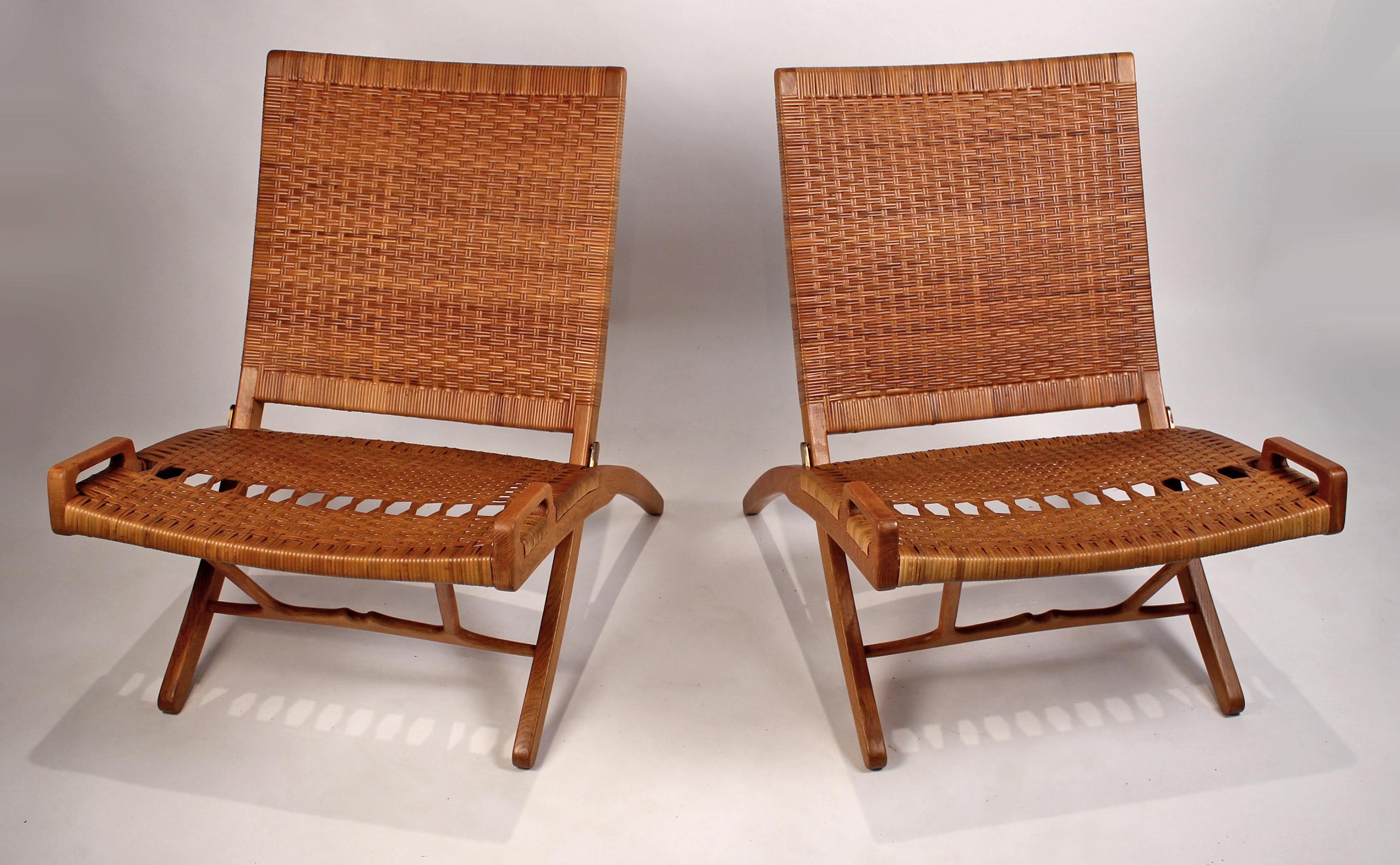 This pair of Danish modern masterpieces is in excellent condition with no breaks to the cane. The oak is also in fine condition. Original 1950s JH stamps are visible on both chairs.