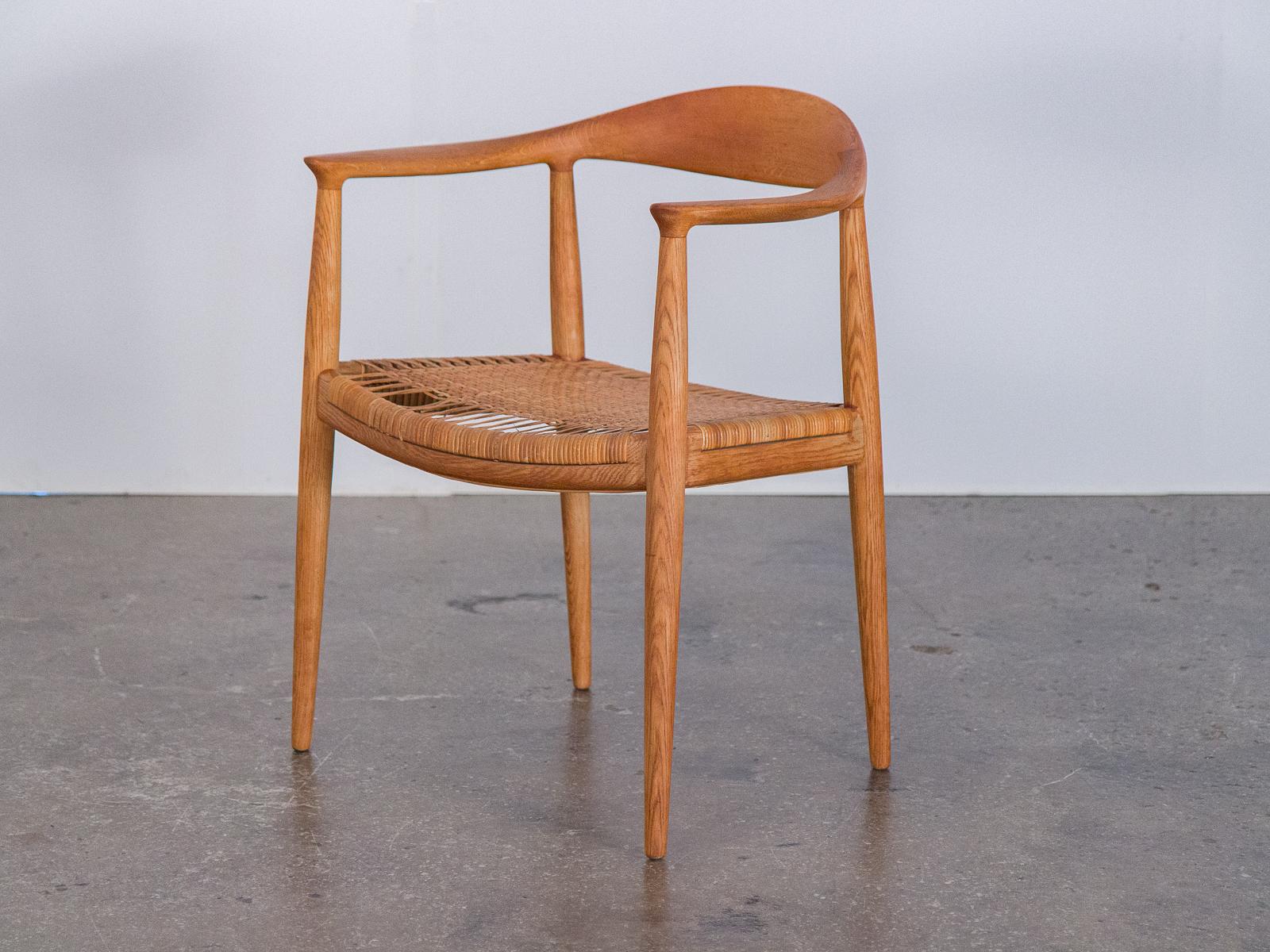 Four matching Model JH 501 dining chairs with cane seats, designed by Hans Wegner for Johannes Hansen, Denmark. This iconic design is best known as 