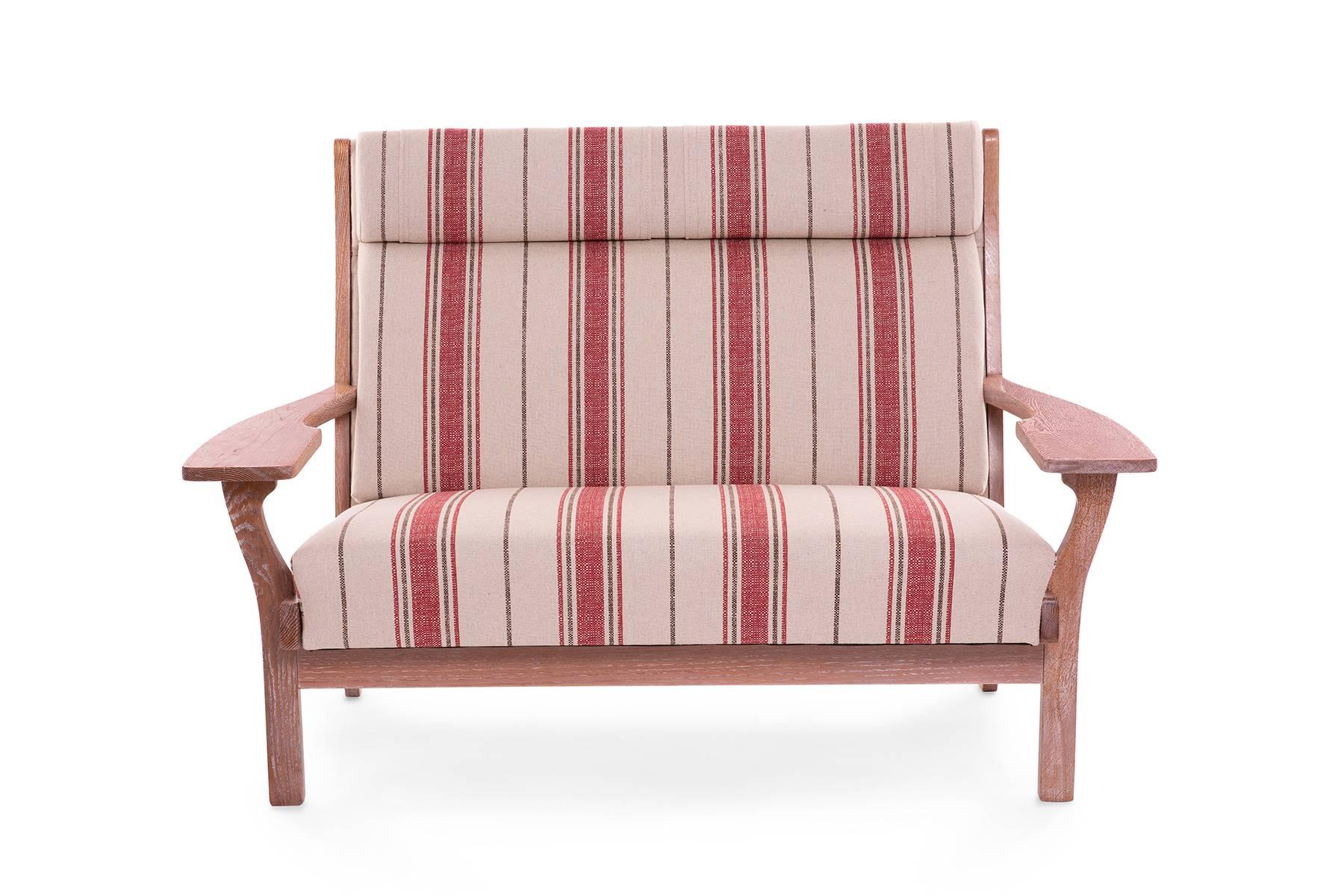 Hans J. Wegner for Getama sofa, circa early 1960s. This example has a solid oak frame that has been newly cerused. The sofa has been newly upholstered in a striped red fabric as well.