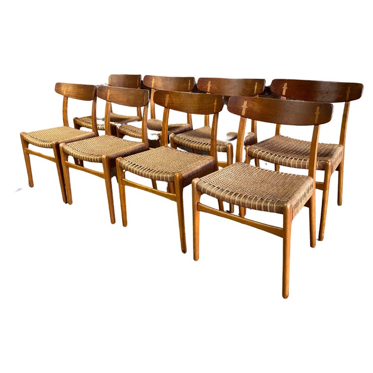A fine set of eight Hans Wegner design CH-23 Teak, Beech and papercord woven seats. The CH-23 design originated circa 1951. A very simple and modern minimalist design where the small design details are the decoration and add to the structural