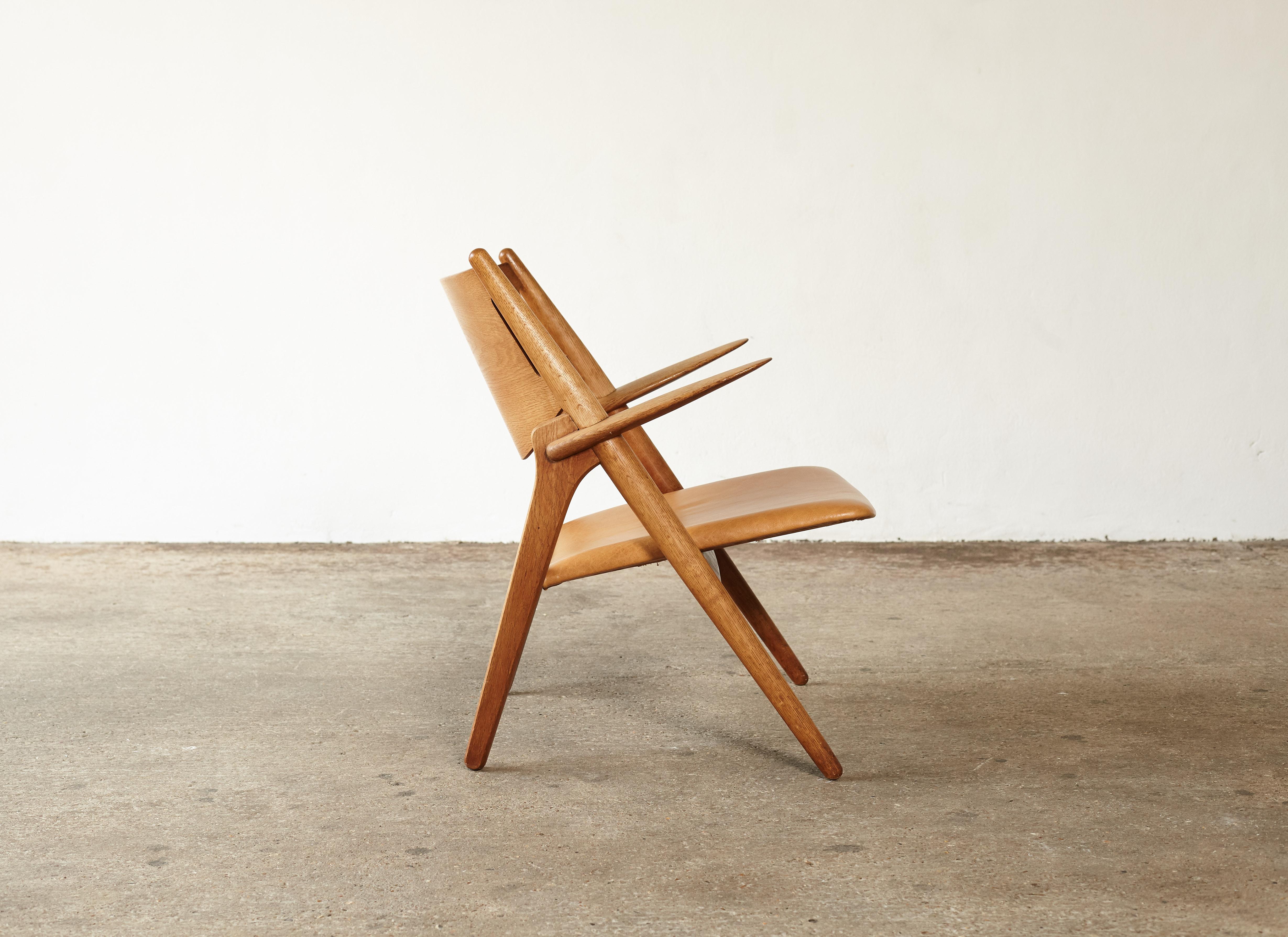 Leather Hans Wegner CH-28 Oak Sawbuck Armchair, 1950s, Denmark