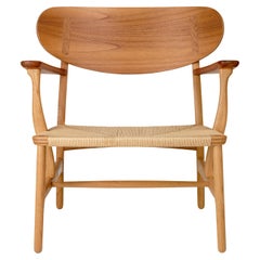 Chaise Hans Wegner 'CH22' en chêne et teck huile pour Carl Hansen & Son