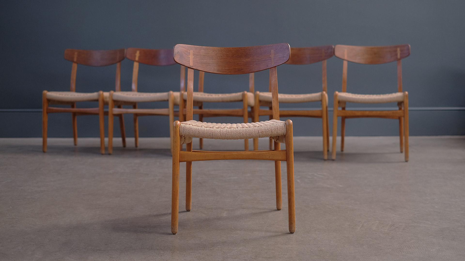 Beautiful set of 6 dining chairs designed by Hans Wegner for Carl Hansen, Denmark. Wonderful condition in solid beech with contrasting teak backrest and exposed joint detail. Superb set of chairs.