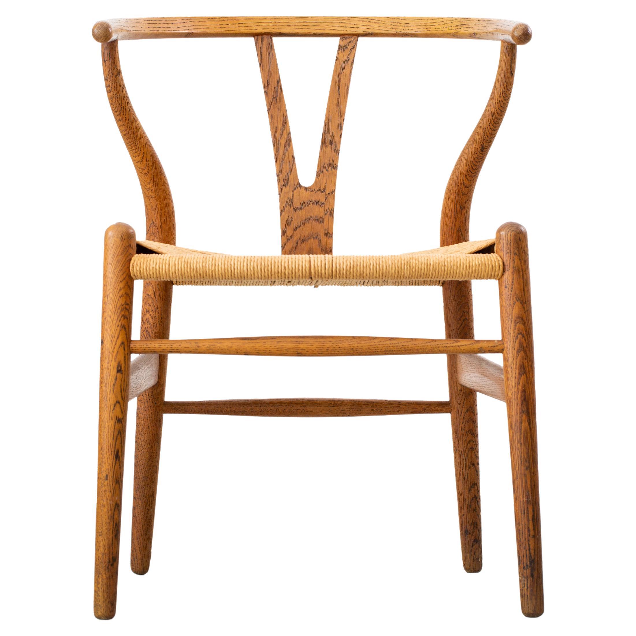 Hans Wegner CH24 Wishbone chair in oak and papercord circa 1959 Illums Bolighus For Sale