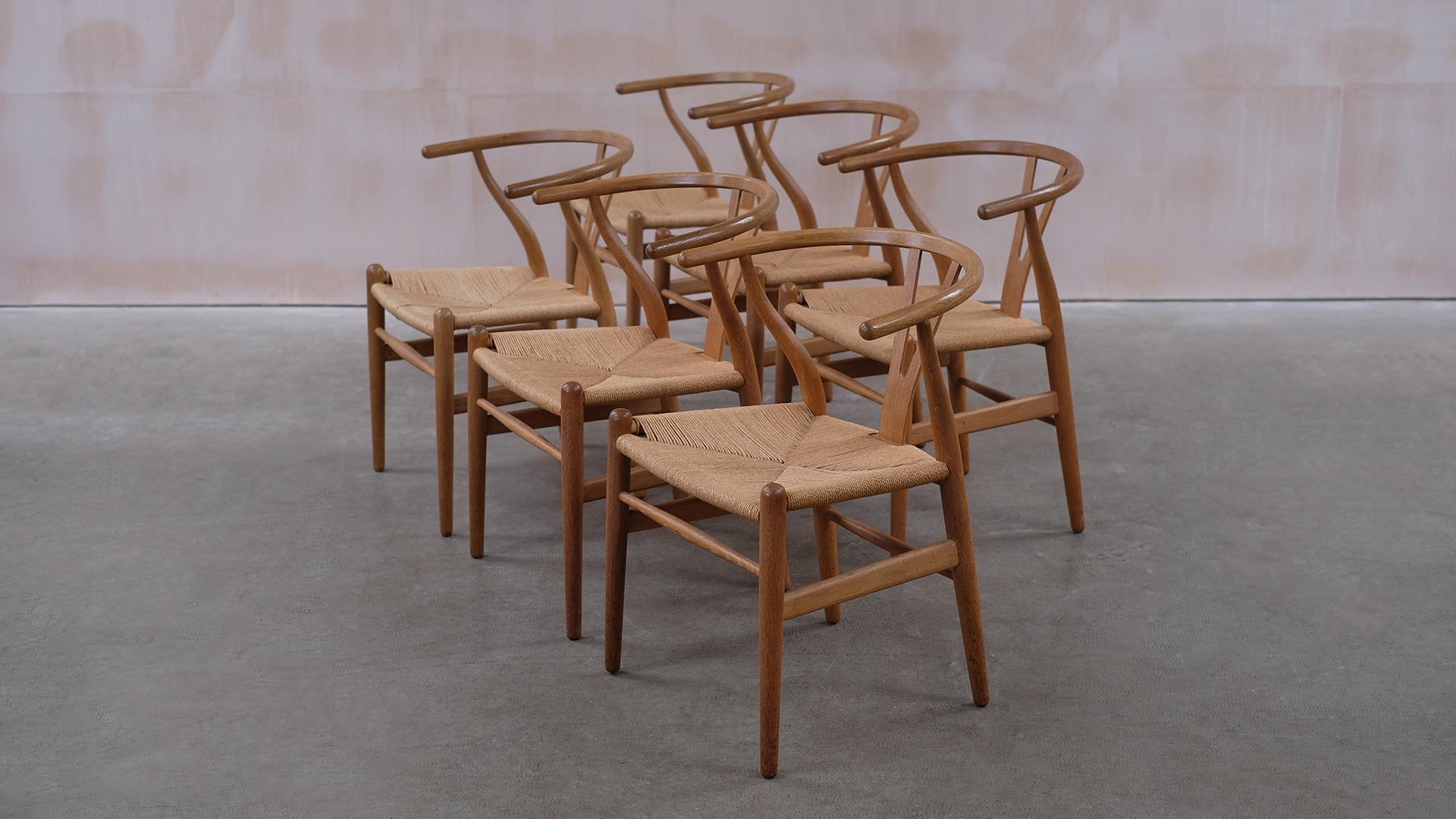 Wonderful set of 6 Wishbone chairs designed by Hans Wegner for Carl Hansen, model CH24. Beautiful condition with warm and naturally aged patina to the sculptural oak frames. Great set of Wegner's classic chair.