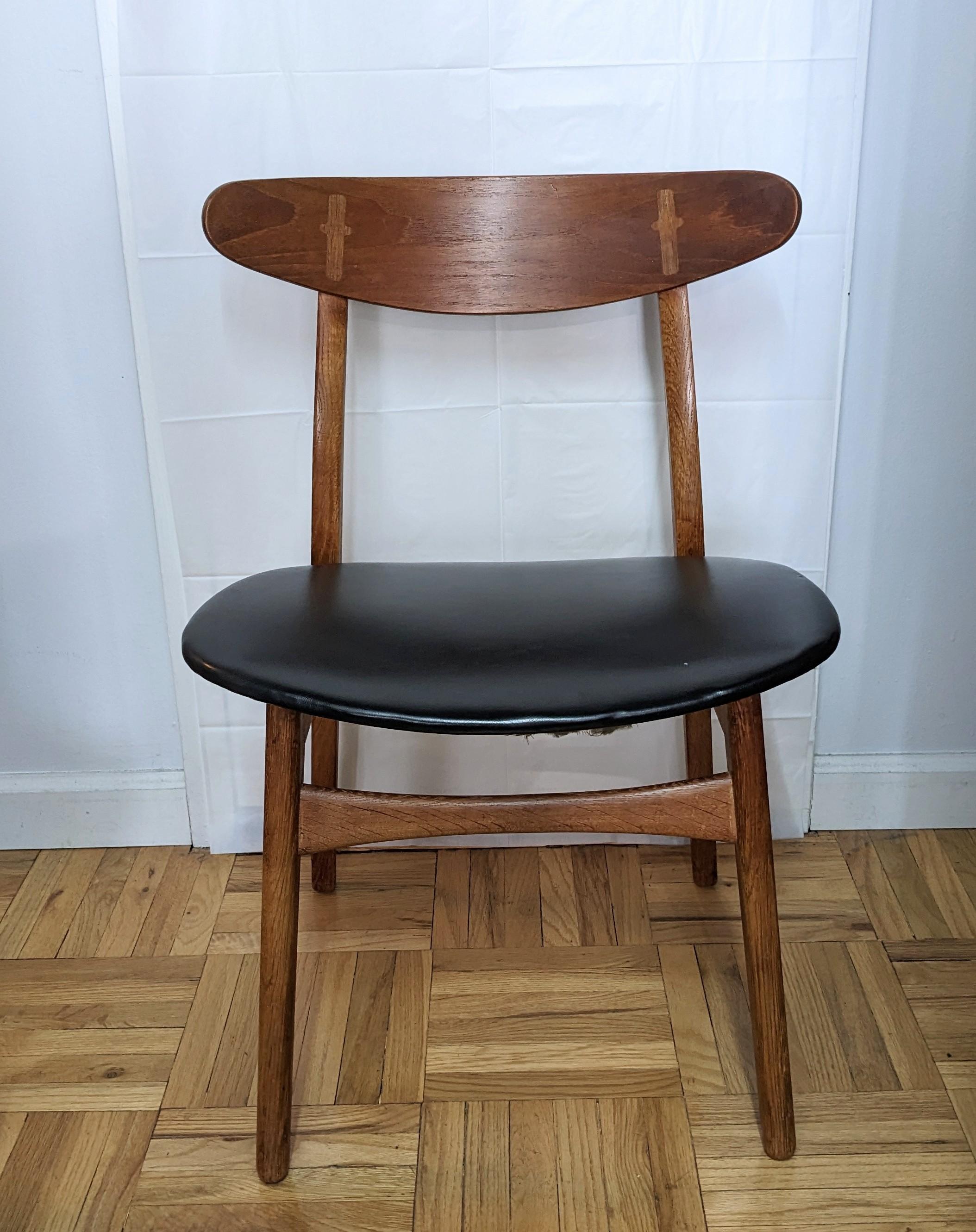 Hans Wegner CH30 Chair is an elegant dining table chair / desk chair with original black leatherette by Hans J. Wegner for Carl Hansen & Søn designed in 1954. This particular example dates from the 1960's.