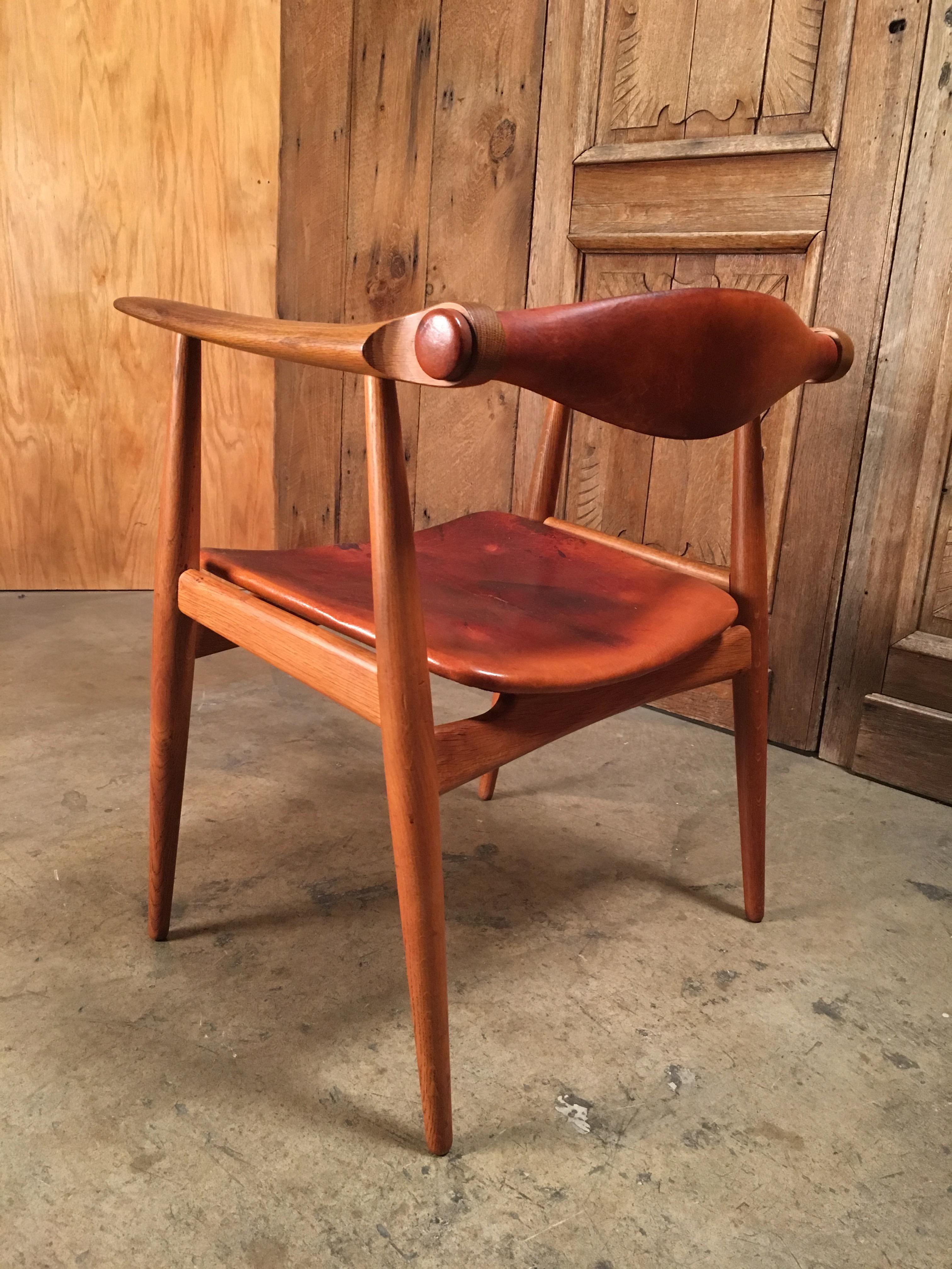 The rotating backrest makes this chair highly comfortable and suitable as an everyday desk chair. Solid oak frame and original leather with great patina. Beautiful detailing. Signed with manufacturers' stamp at the underside of the seat.