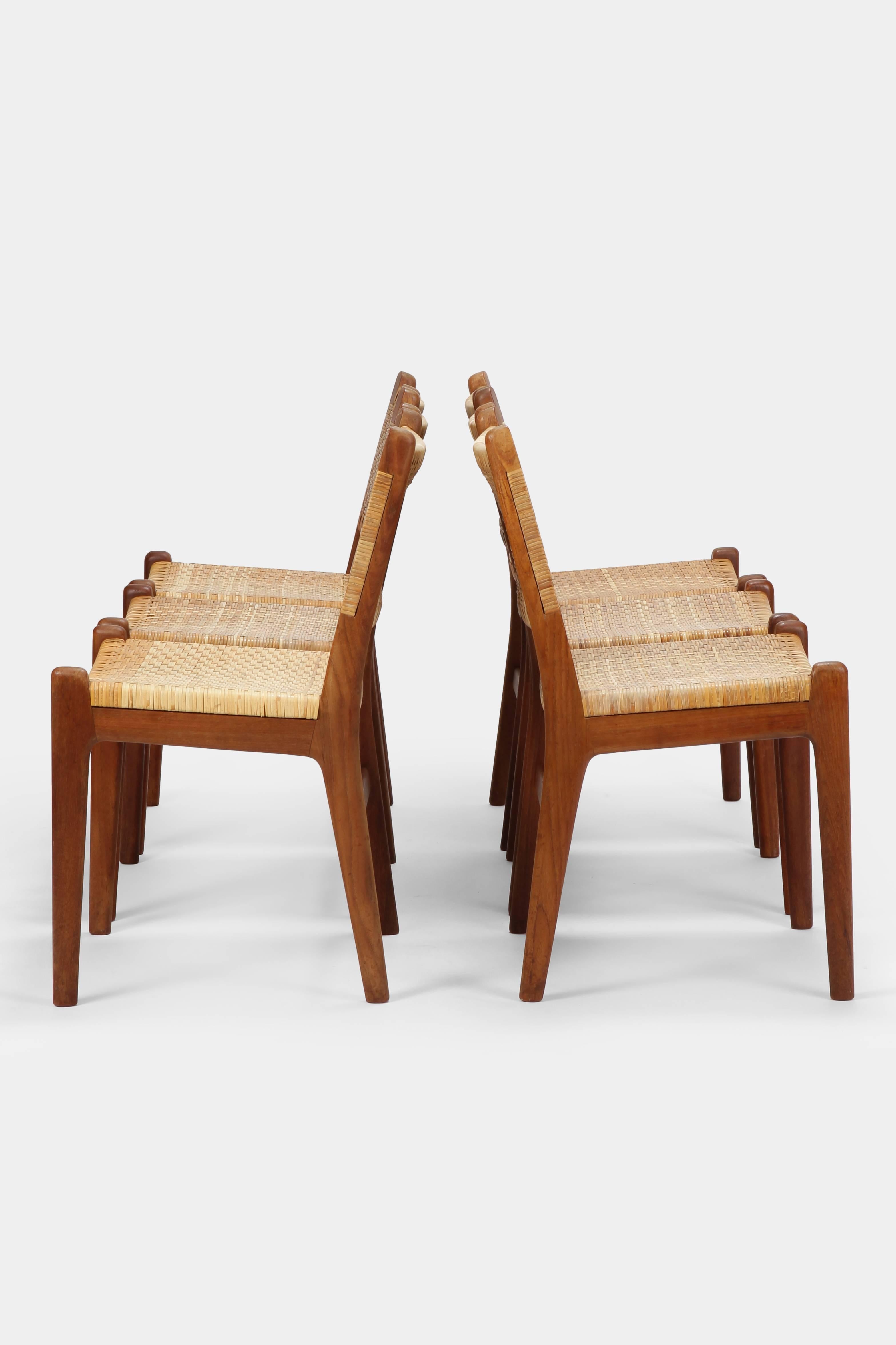 Hans J. Wegner dining chairs CH31 manufactured by Carl Hansen & Son in the 1960s in Denmark. Beautiful and very rare chairs with exposed teakwood frame and orante attached woven cane upholstery which was slightly restored.