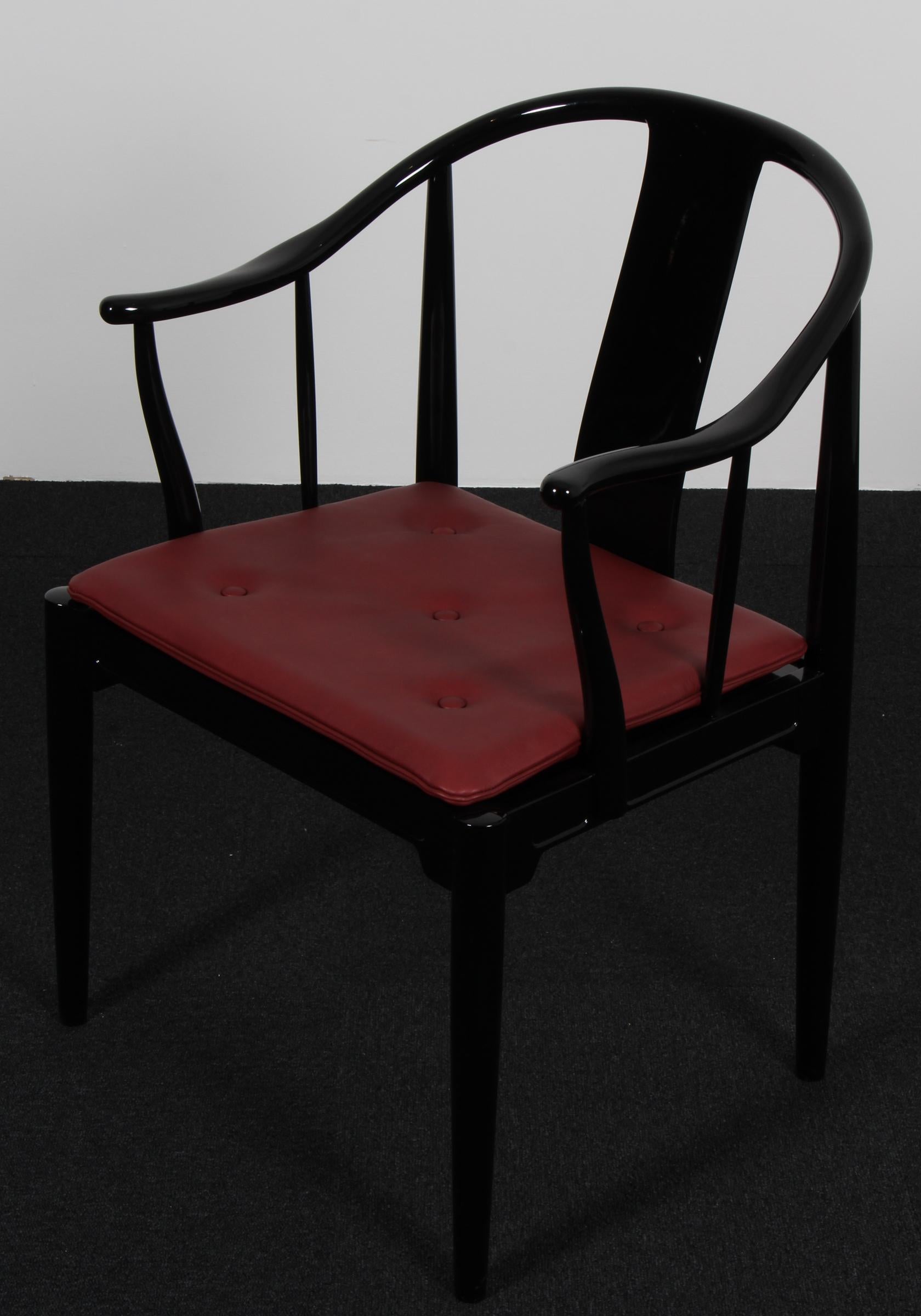 Hans J. Wegner famous and beautiful chair is an adaptation of an old Chinese chair of the Ming dynasty; “China Chair”. A very comfortable armchair made in black painted. Loose seat cushions new upholstered with indian red aniline leather, fitted