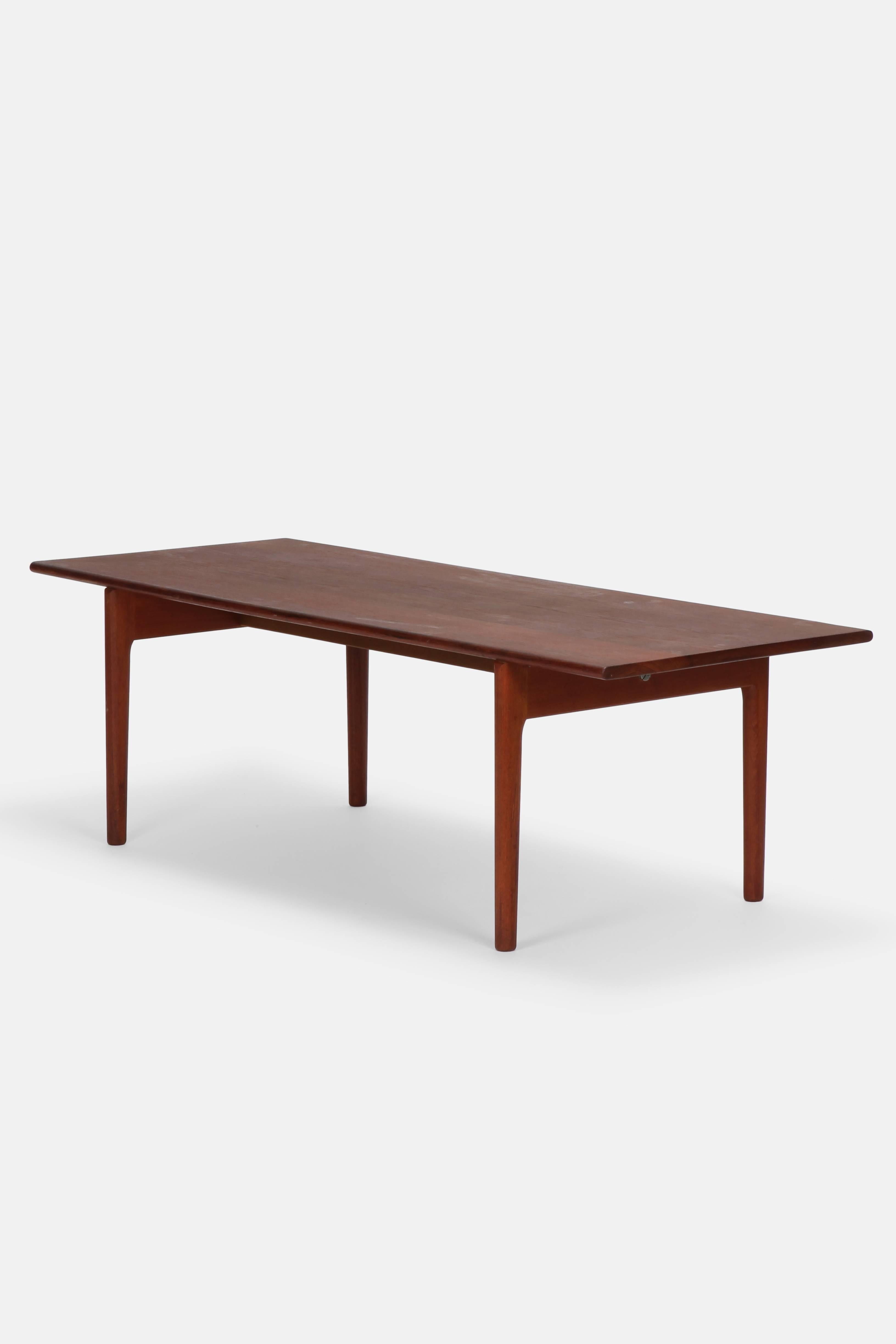 Hans J. Wegner coffee table model AT-15 manufactured by Andreas Tuck in the 1960s in Denmark. Solid teak wood with easily recognizable Hans J. Wegner design. Including makers stamp on the bottom.