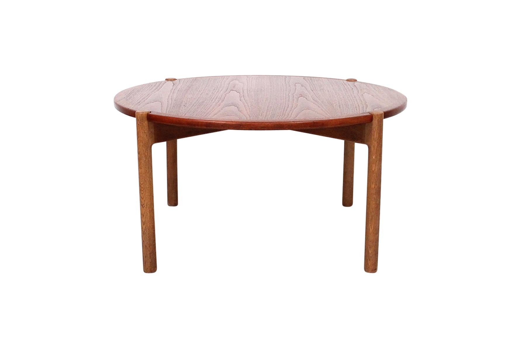 Hans J. Wegner designed coffee table for Johannes Hansen. Top of this table reverses for use with a teak or black laminate surface on an oak base. Table is known as Model JH 564. Branded with the Johannes Hansen mark to underside of base.