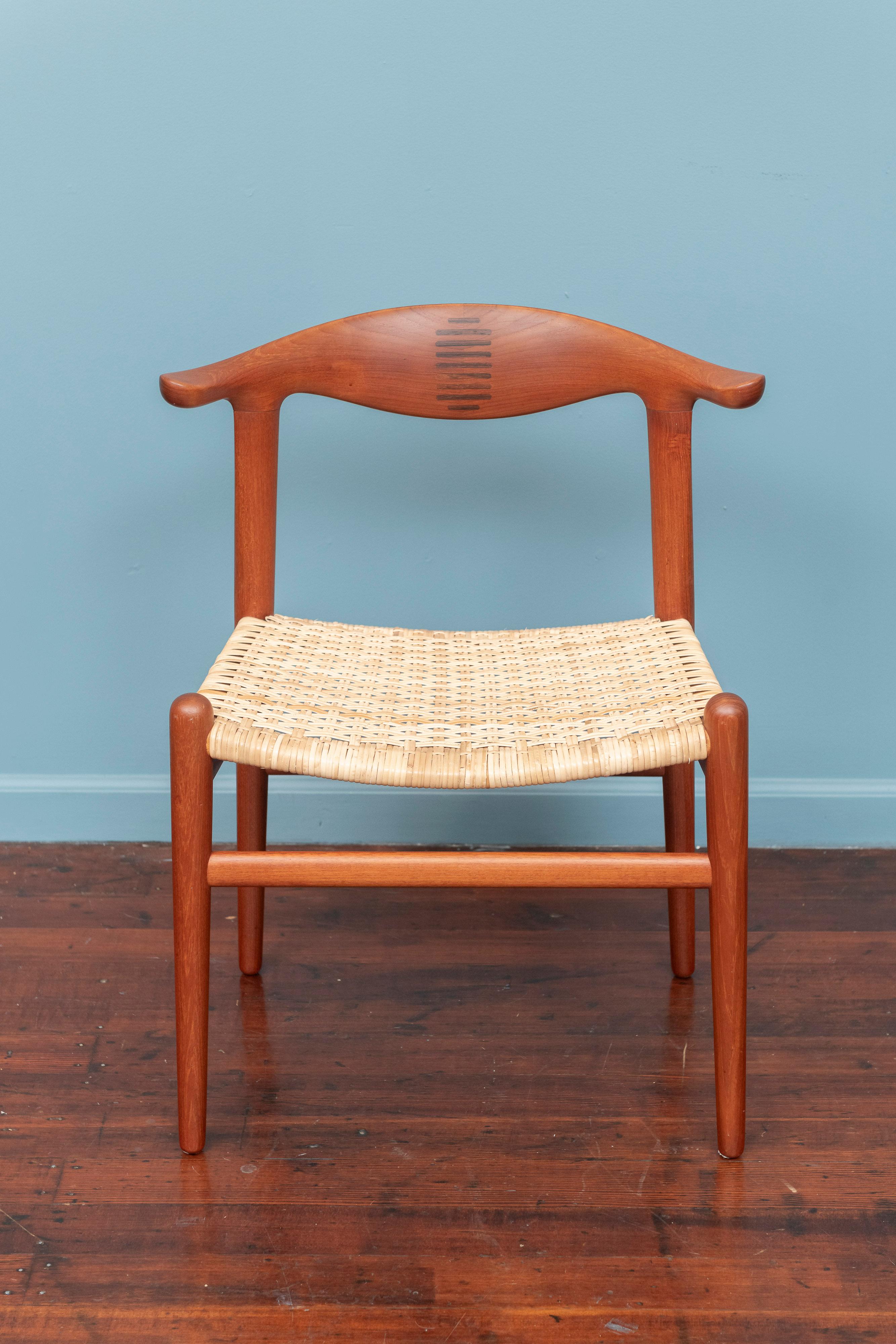 Hans J. Wegner design cow horn chair, model JH-505 for Johannes Hansen. Rare dining or desk chair by the master Hans J. Wegner in solid teak with rosewood inlay. New cane seat, in very good original condition. 
