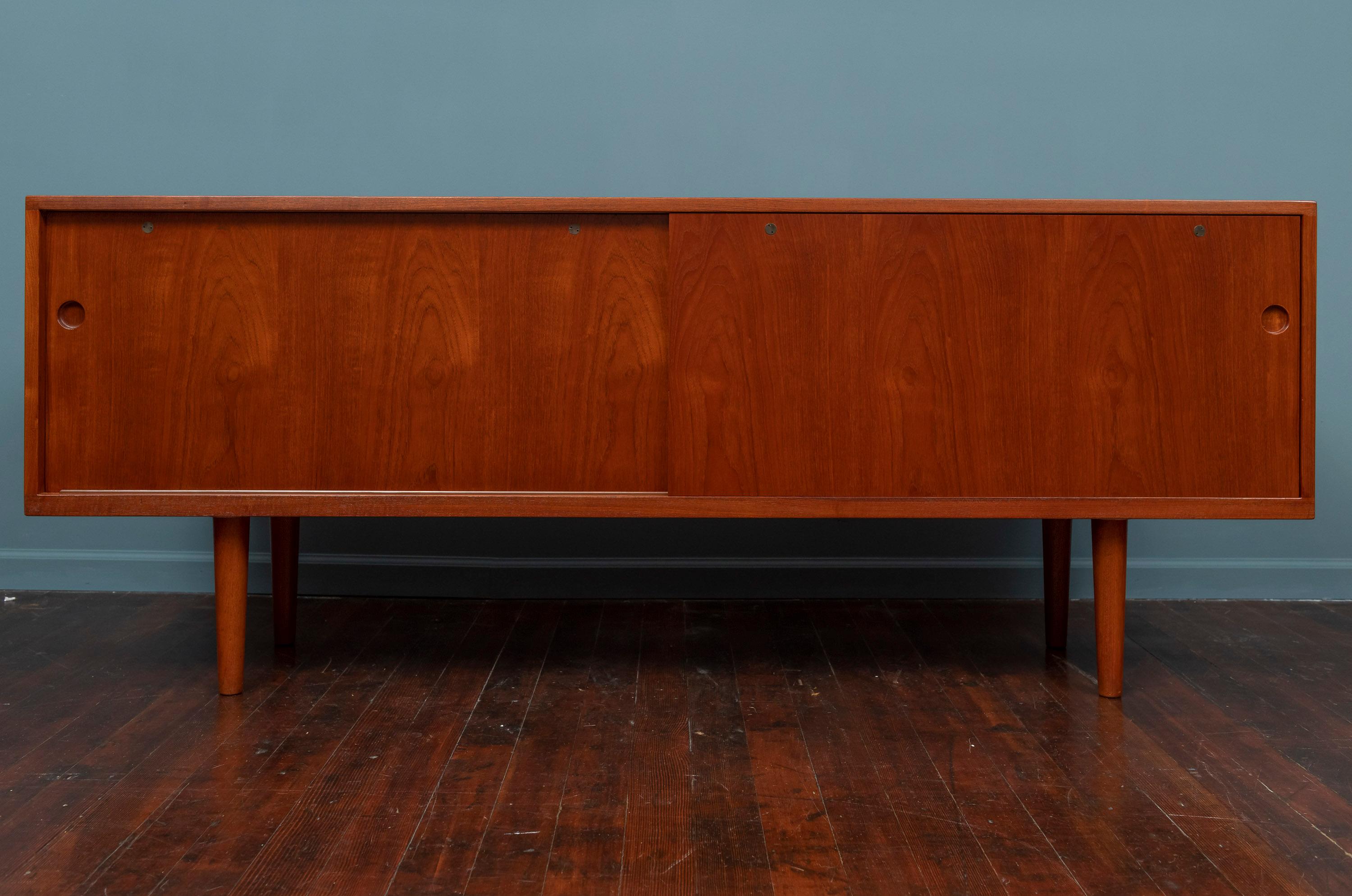 Hans Wegner design teak credenza for Ry Mobler Model 26, Denmark. Sophisticated in its simplicity with high quality construction techniques and attention to detail. Newly refinished and ready to install.