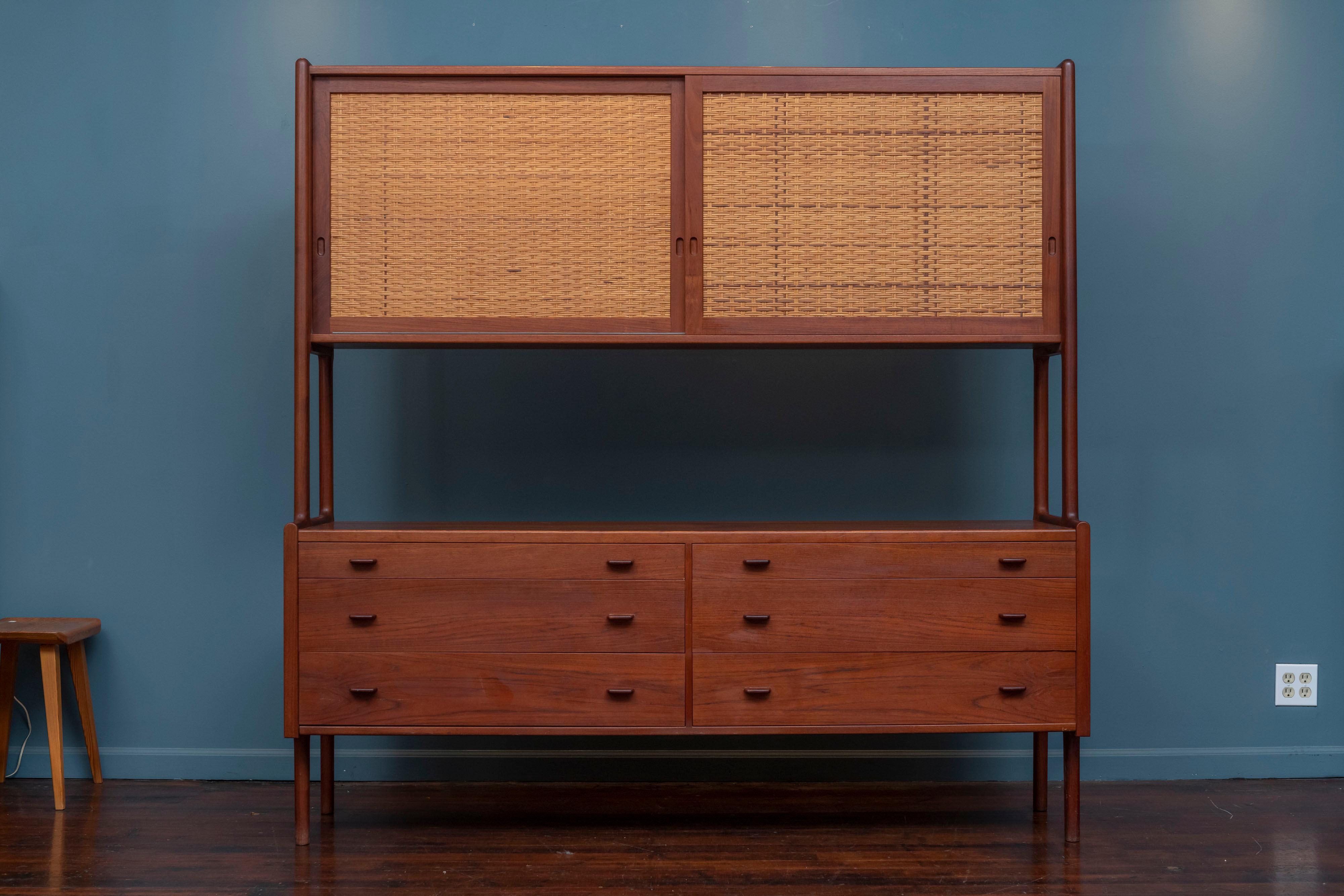 Hans Wegner credenza or hutch for RY-Mobler, Denmark. High quality construction and materials executed by Hans Wegner for Ry Mobler, Model RY 20. Beautiful warm colored teak with dramatic grains thorought and two caned sliding doors with two