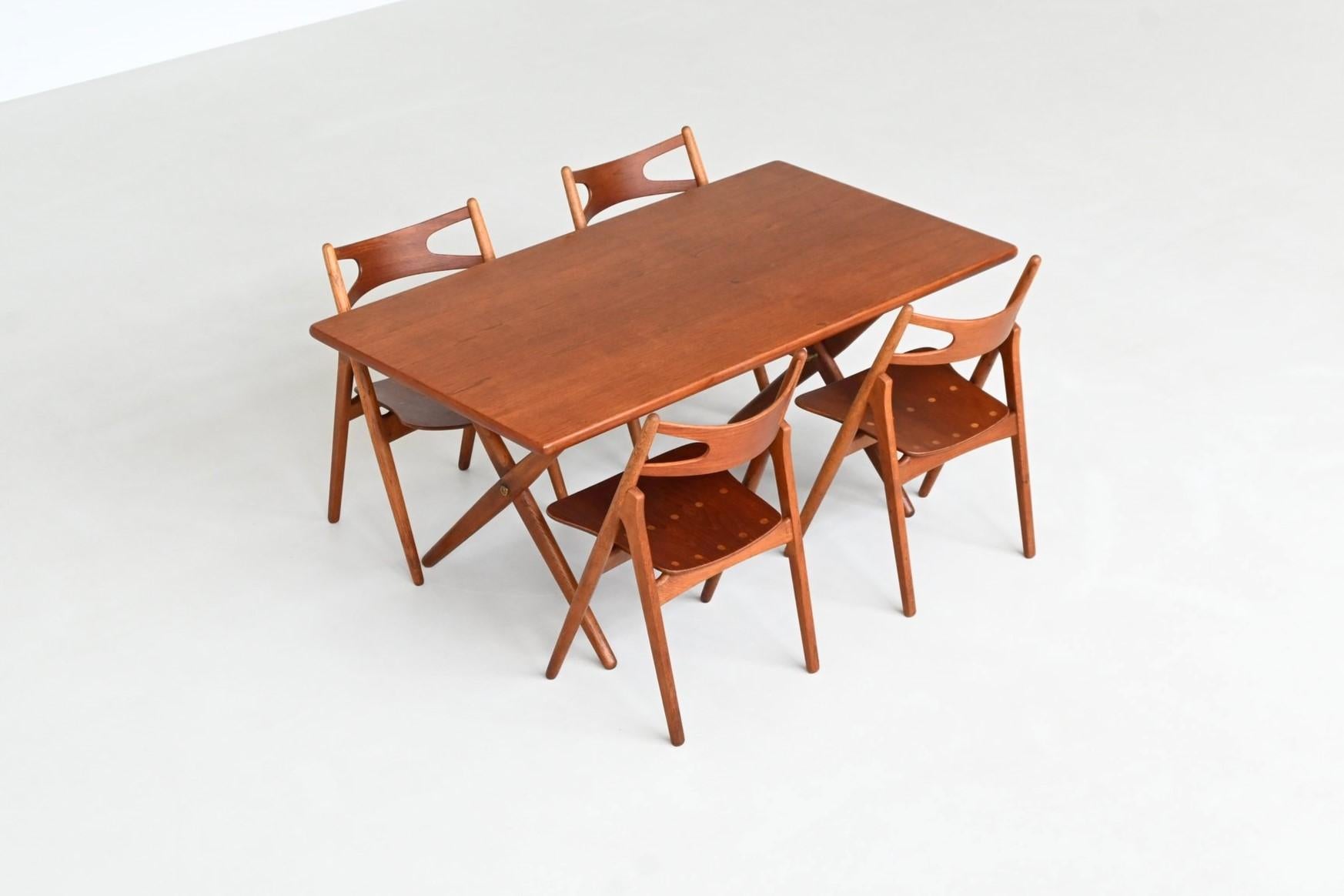 Beautiful cross-leg dining table model AT 303 designed by Hans J. Wegner for Andreas Tuck, Denmark 1950. This AT 303 dining table is a refined expression of mid-century Danish craftsmanship and minimalism. Crafted from warm, richly grained teak,