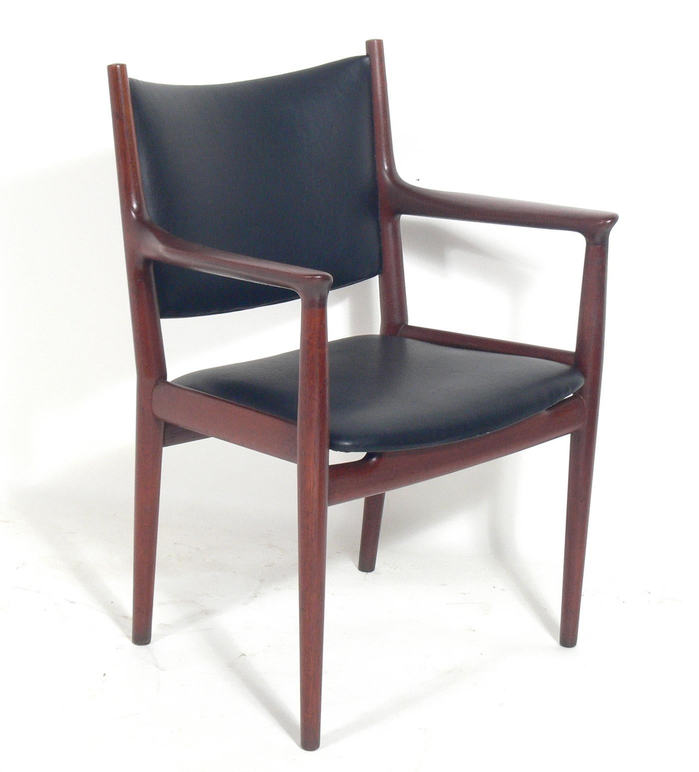 Set of Eight Danish Modern Dining Chairs, Model JH 713, designed by Hans Wegner for Johannes Hansen, Denmark, circa 1960s. They have been reupholstered in a buttery soft, leather like, low maintenance black vinyl.