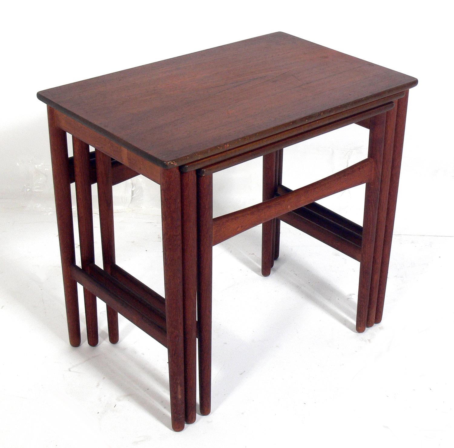 Danish modern teak nesting tables, designed by Hans Wegner for Andreas Tuck, Denmark, circa 1960s. They have been cleaned and Danish oiled.