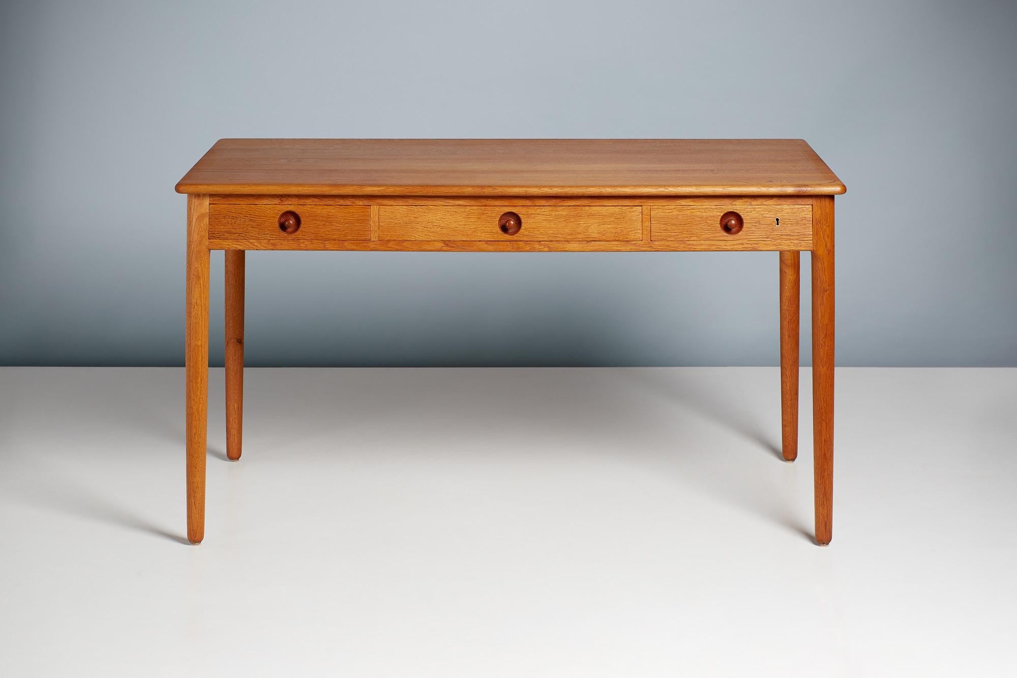 Hans Wegner - Model 305 desk, 1953

Oak desk from Danish icon Hans Wegner produced by master-cabinetmaker Ejner Pedersen for his company PP Mobler c1970s. The whole desk including legs, drawers, top and frame are made from solid, patinated oak which