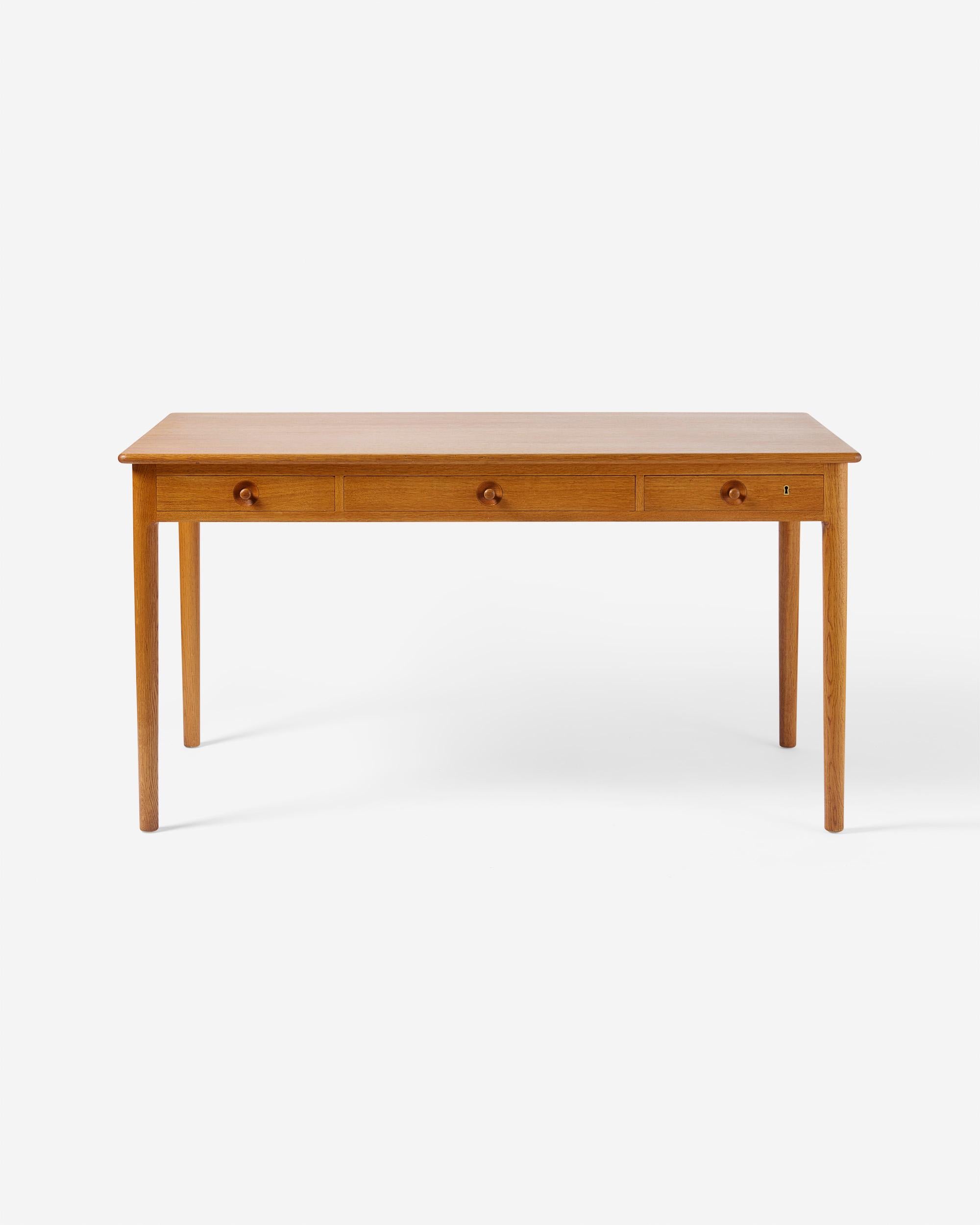 Hans Wegner - Model 305 desk, 1953

Oak desk from Danish icon Hans Wegner produced by master-cabinetmaker Ejner Pedersen for his company PP Mobler c1970s. The whole desk including legs, drawers, top and frame are made from solid, patinated oak which
