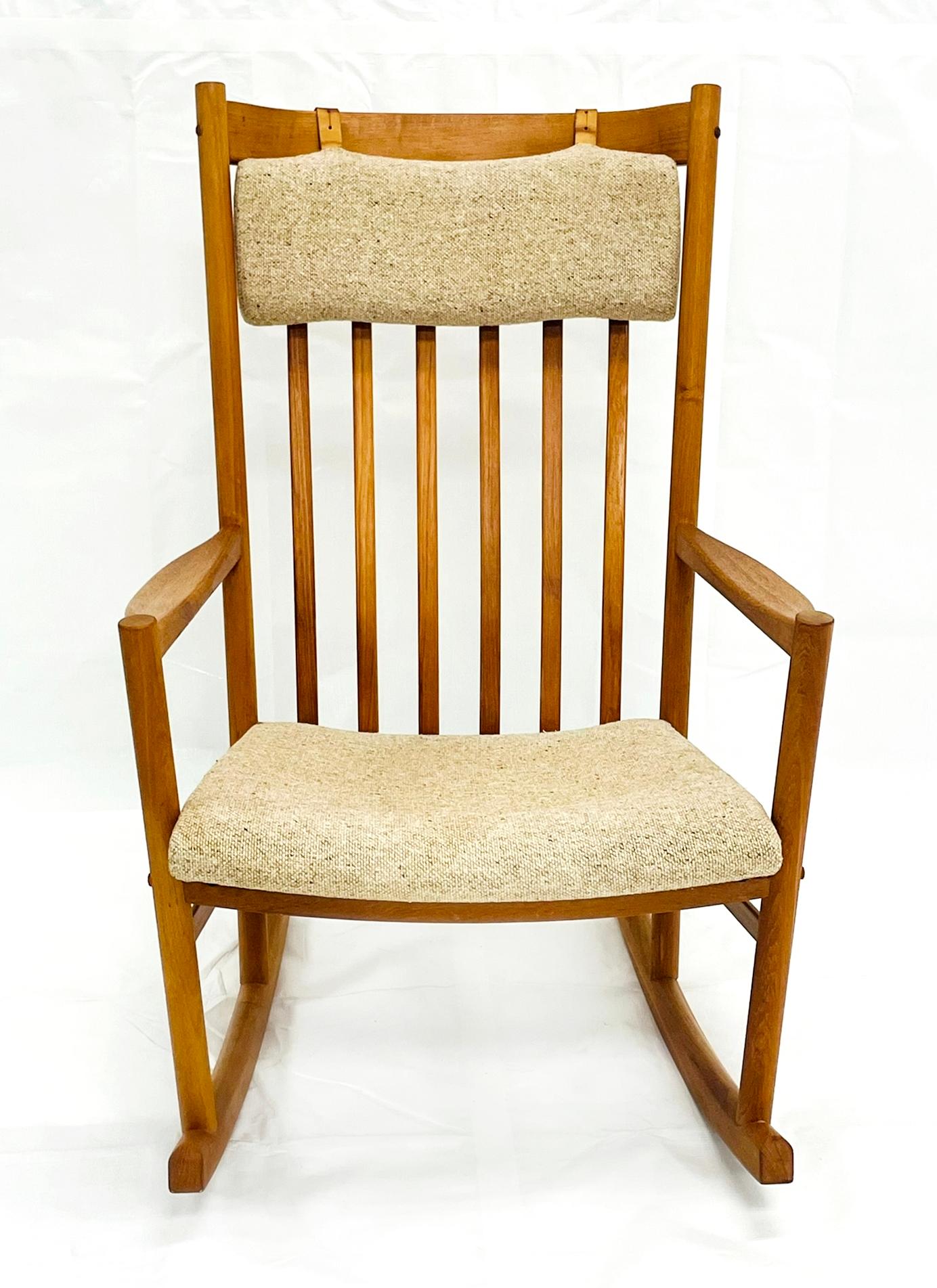 Elegant Danish Modern teak rocking chair designed by Hans J. Wegner for Tarm Stole-og Møbelfabrik A/S, Denmark, circa 1960s. A quintessential example of Wegner’s mastery of form and function, this chair blends sculptural craftsmanship with ergonomic