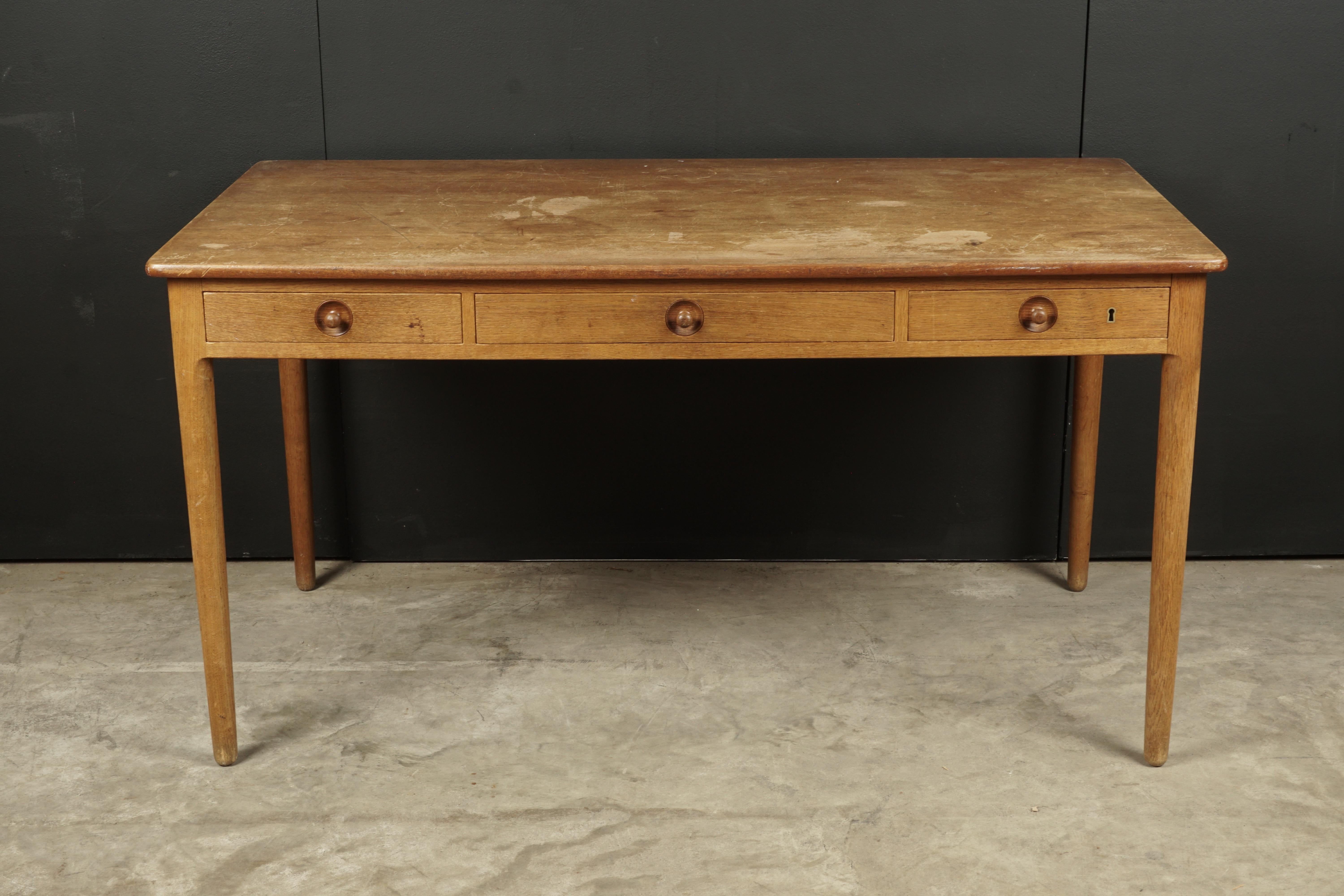 Rare Hans Wegner desk in oak, Model AT 305, from Denmark, circa 1960. Three drawer model in solid oak construction. Manufactured by Andres Tuck, Denmark.