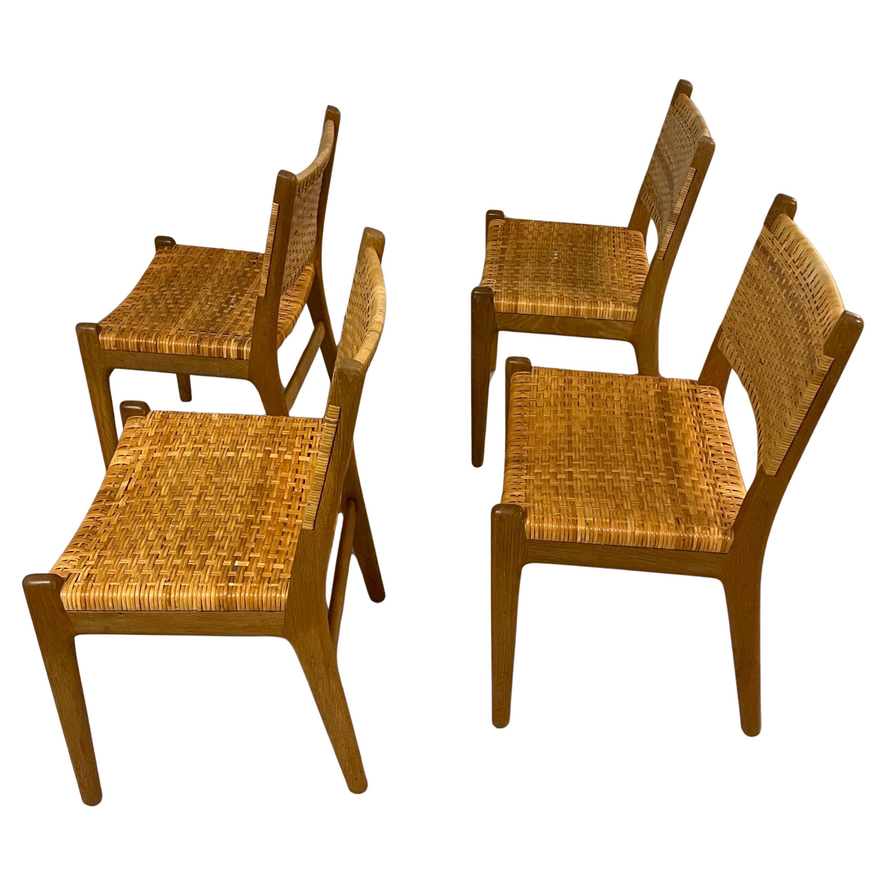 A very rare set of the model CH32 dining chair designed by Hans J. Wegner made for Carl Hansen & Sons in the 1950s. Solid oak with beautiful grain  and rattan cane on the seats and back. This model is no longer being produced and is hardly to find.