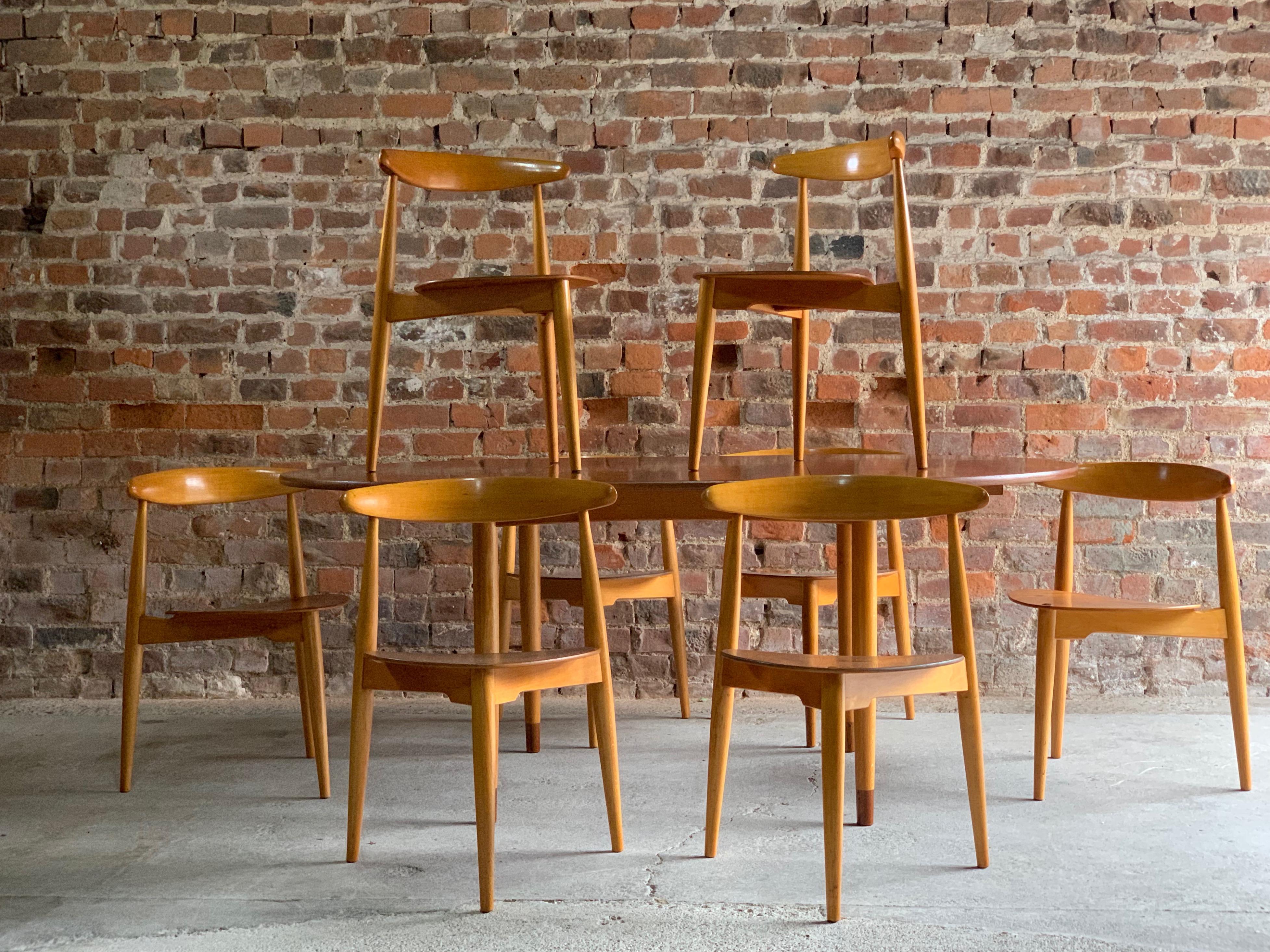 Hans J Wegner ‘The Heart' dining suite made in Denmark by Fritz Hansen circa 1950, with eight ‘heart’ chairs Model FH4103 made from teak and beech frames, the chairs are all stackable, the matching table is an extremely rare four legged version with