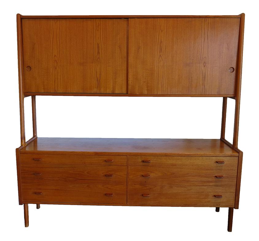 This model RY20 from the premier Danish designer, Hans Wegner, is a spectacular example of the Danish modern movement. The craftsmanship is extraordinary with the vertical stay extending through the top and bottom cabinets, resolving as the leg.