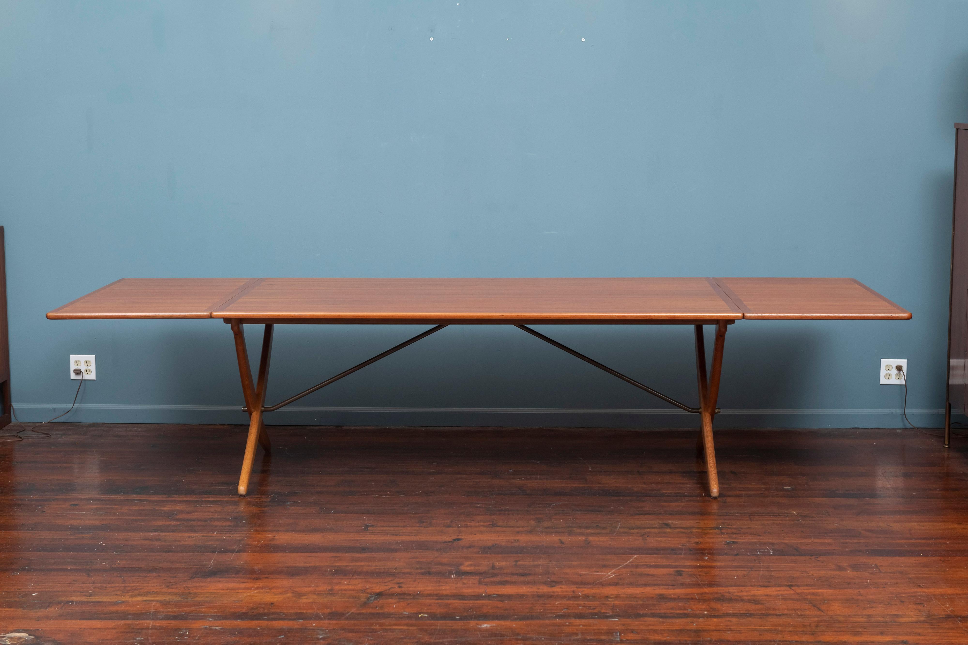 Hans Wegner design drop leaf dining table for Andreas Tuck, Model AT-314. 
Rare and impressive larger than any other Wegner dining table, often referred to as the saber leg table, purchased at Illums Bolighus in Copenhagen. 
Newly refinished and