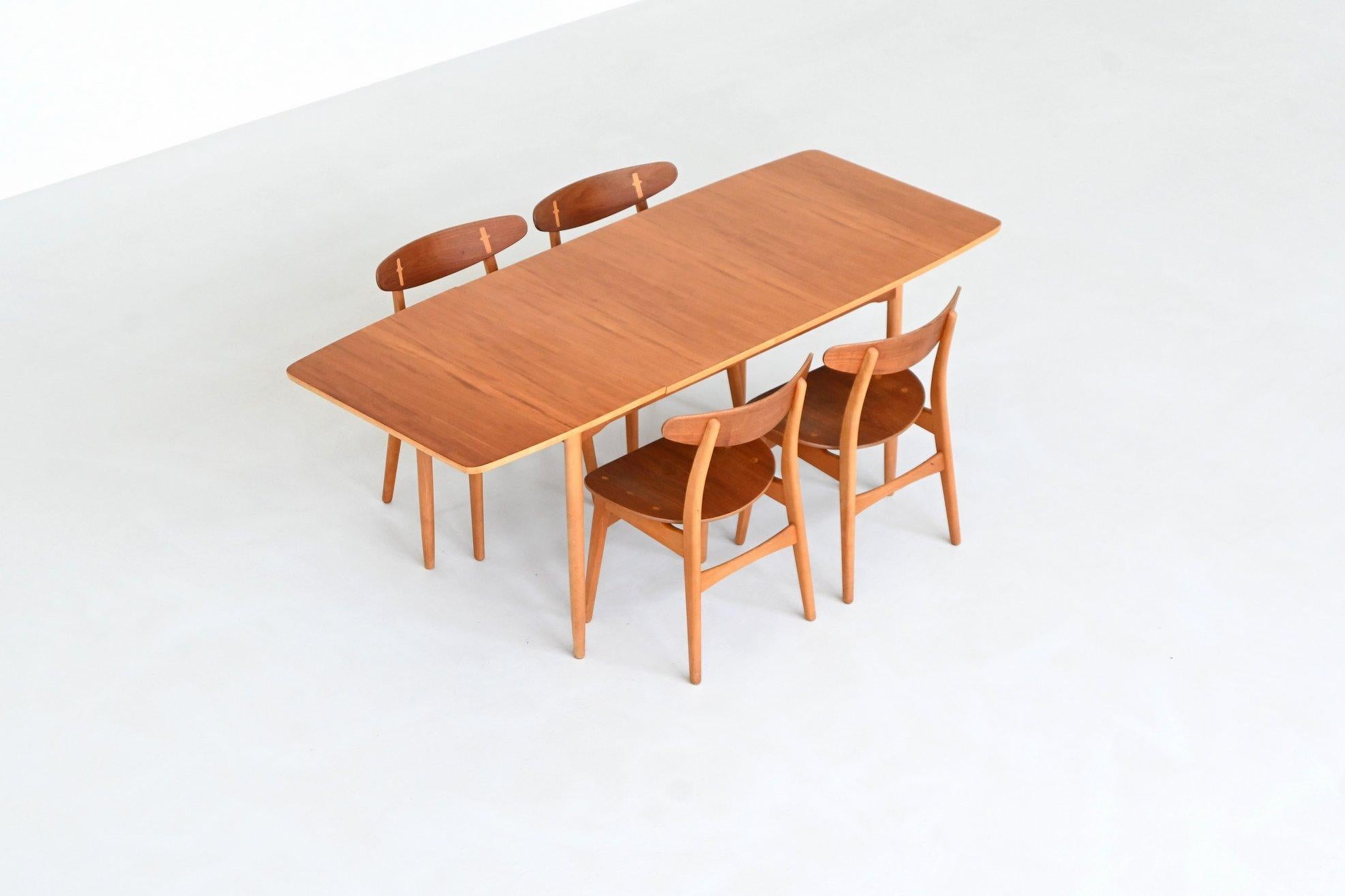 Rare drop-leaf dining table designed by Hans J. Wegner, Denmark 1950. This elegant piece features a refined combination of solid beech legs and a teak veneered top, showcasing Wegner’s mastery of functional design and natural materials. The softly