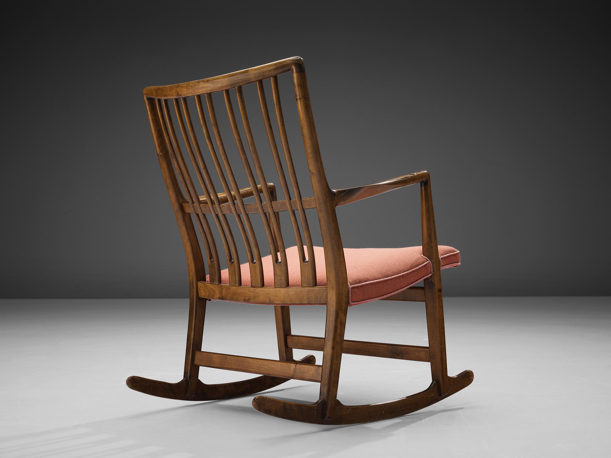 Hans J. Wegner for Mikael Laursen, rocking chair model ML-33, stained beech, fabric Denmark, 1940s.

This rocking chair is an early design of Hans Wegner, produced by master-carver and cabinetmaker Mikael Laursen. Model ML-33 is known as the first