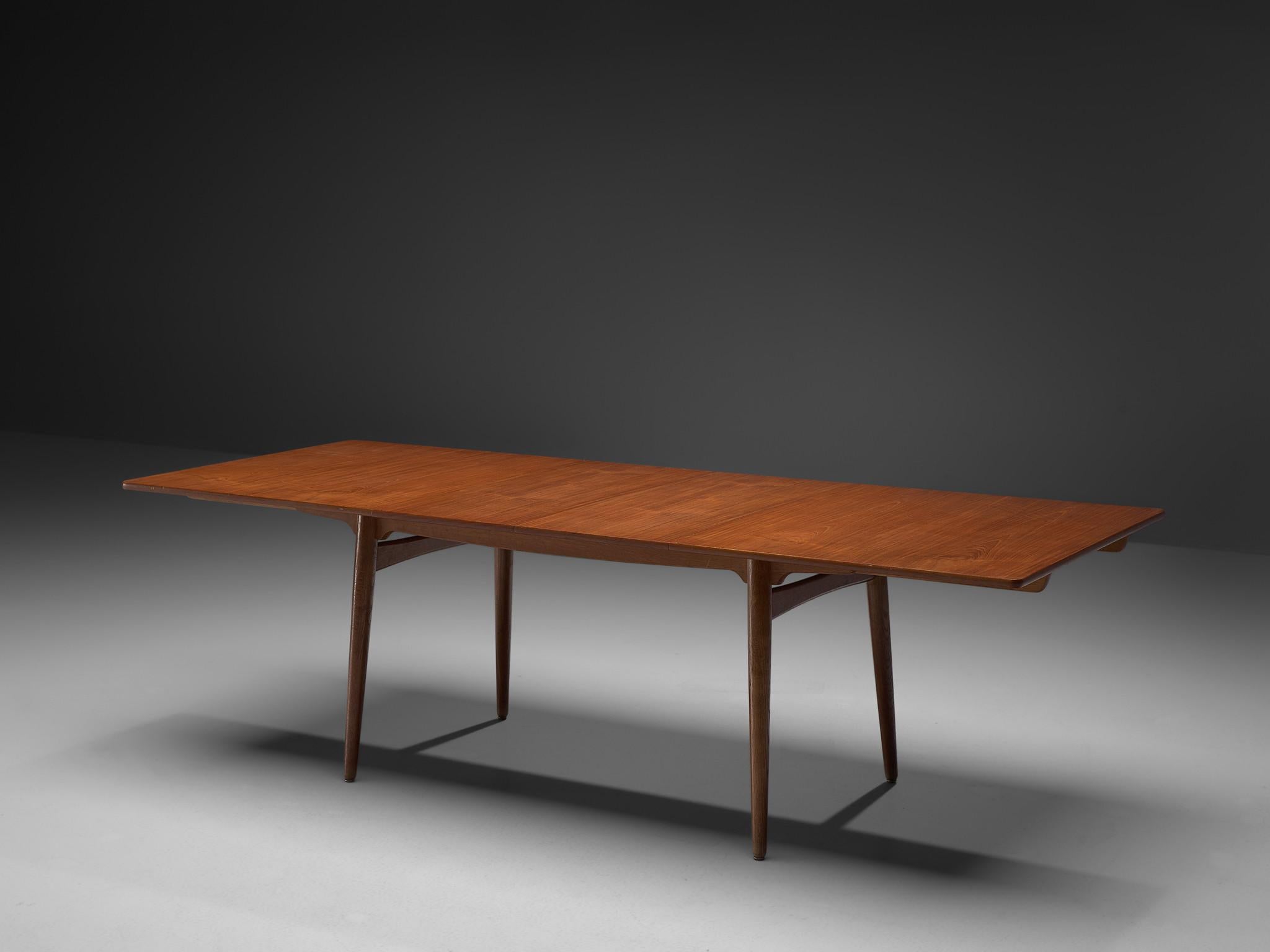 Hans J. Wegner for Andreas Tuck, 'AT-310', teak and oak, Denmark, 1950s.

This extendable AT-310 dining table designed by Hans J. Wegner is made with a teak top and has extra leaves in order to expand the piece from a six-seat (160cm) to a