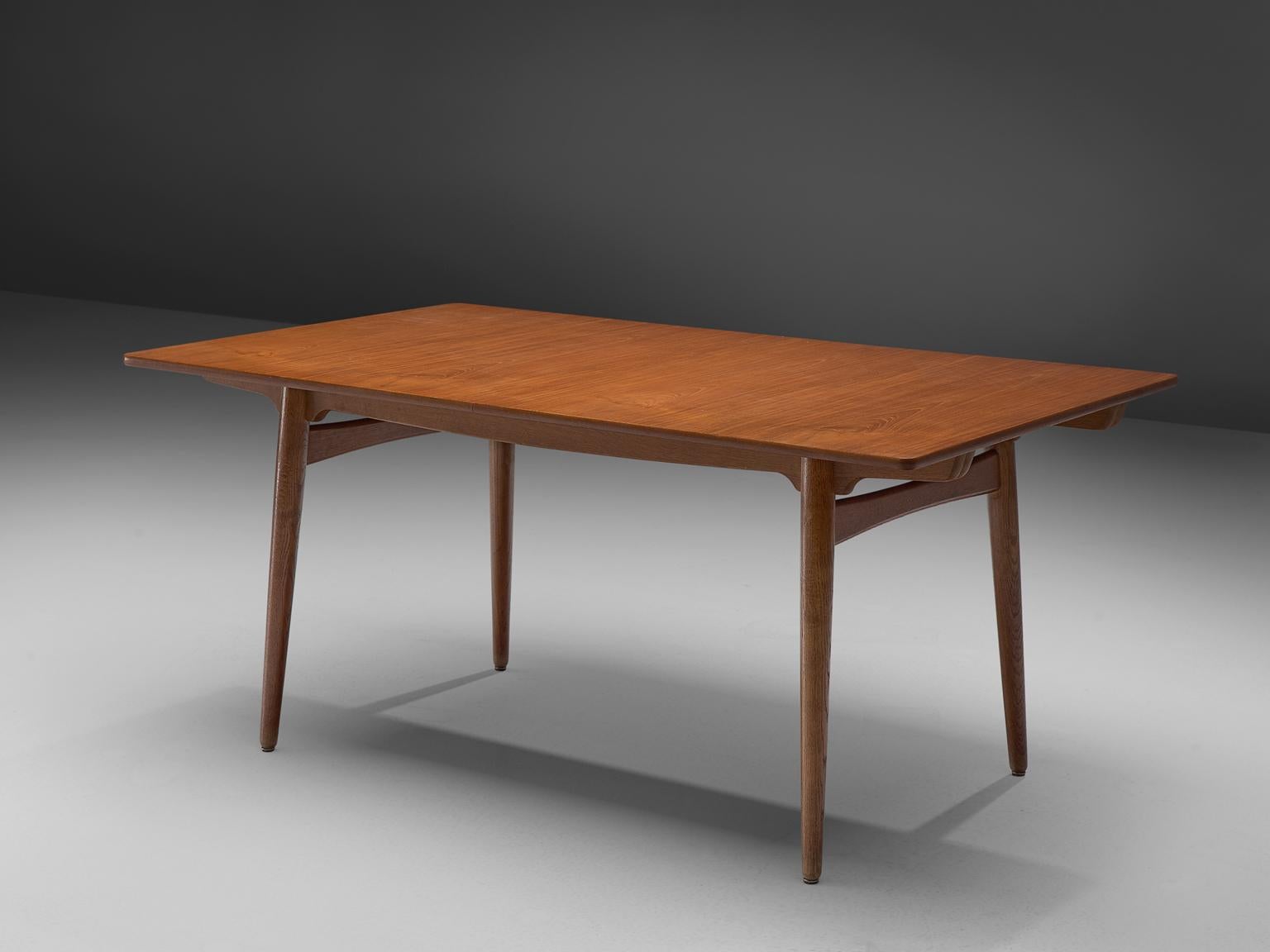 Hans J. Wegner for Andreas Tuck, 'AT-310', teak and oak, Denmark, 1950s.

This extendable AT-310 dining table designed by Hans J. Wegner is made with a teak top and has extra leaves in order to expand the piece from a six-seat (160cm) to a ten-seat