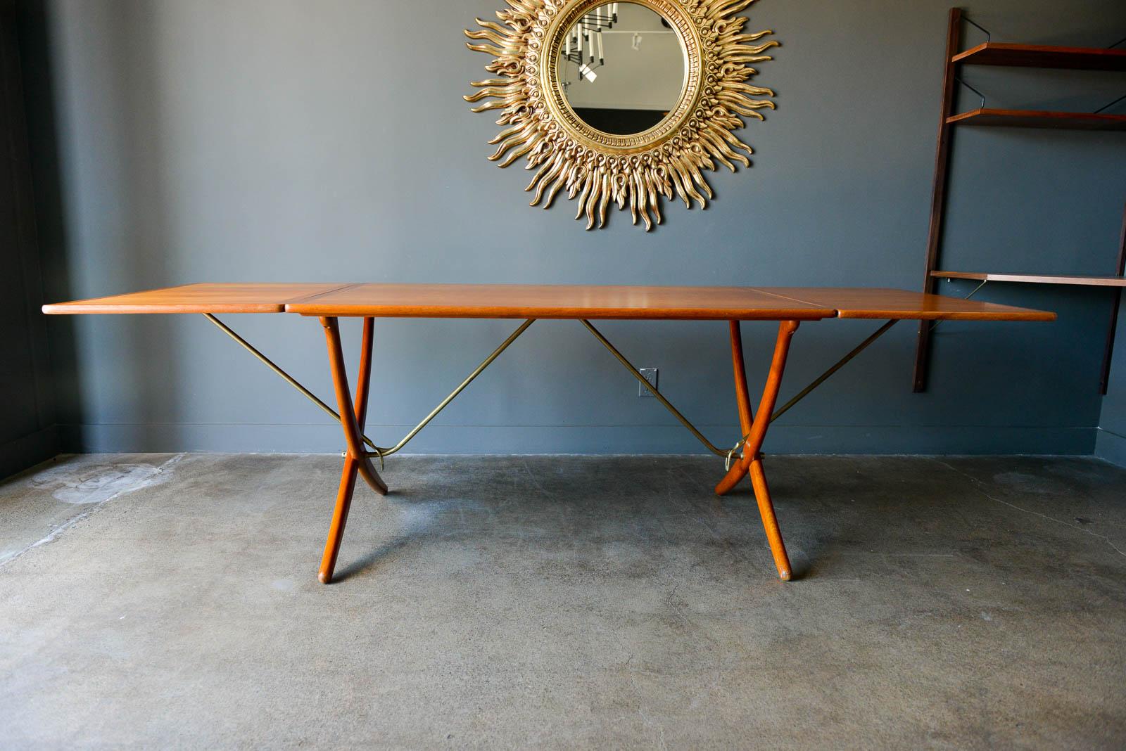 Early Hans Wegner for Andreas Tuck Model AT-304 drop leaf dining table, circa 1955. Original excellent condition, hardly used with extremely light wear on feet and top, almost perfect with no need for restoration. Solid brass stretcher bars and