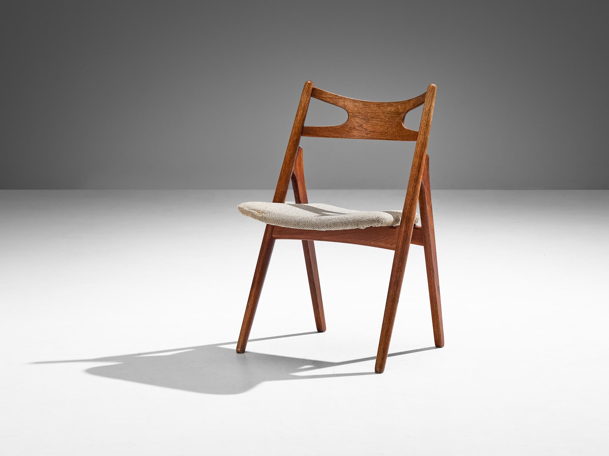 Hans J. Wegner for Carl Hansen & Søn, 'Sawbuck' dining chair, model CH29, teak, beige fabric, Denmark, design 1952 

Hans Wegner's chair exemplifies a solid construction, despite its minimalistic appearance. The chair's distinct feature is its