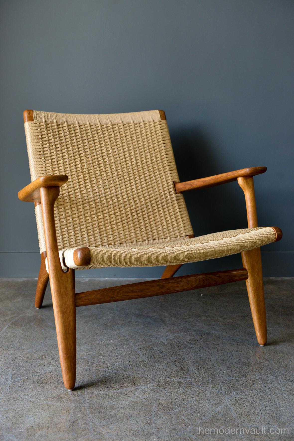 Hans Wegner for Carl Hansen & Son CH 25 lounge chair, circa 1950. Early model, marked on underside with stamp and Danish maker's mark. Early example in hand oiled oak. New papercord seat and back restored to exacting standards as the original.