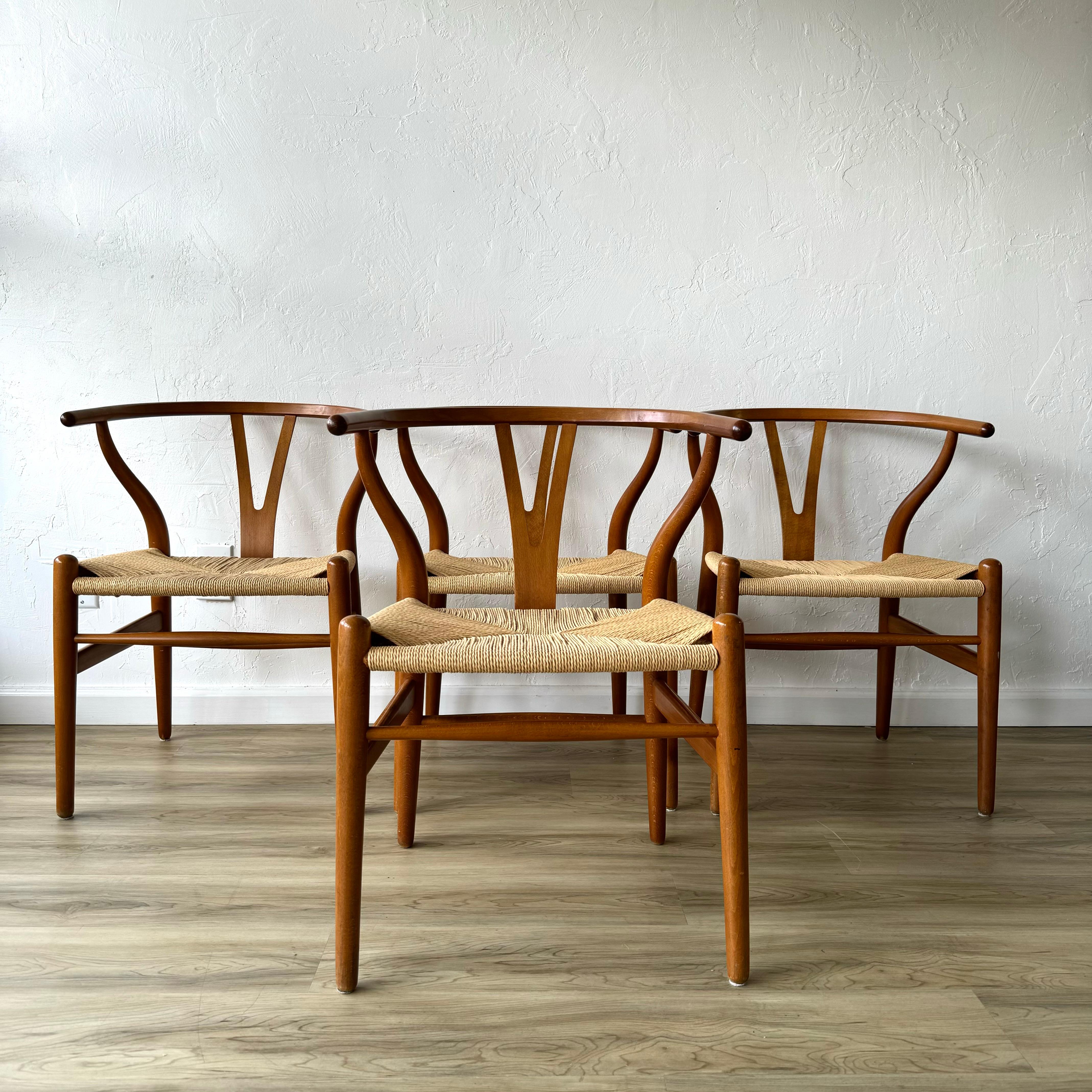 A fantastic set of 4 Hans Wegner designed wishbone chairs for Carl Hansen. These have been restored snd newly recorded with traditional danish papercord. These are made of beech wood and probably date to the 1970s.
