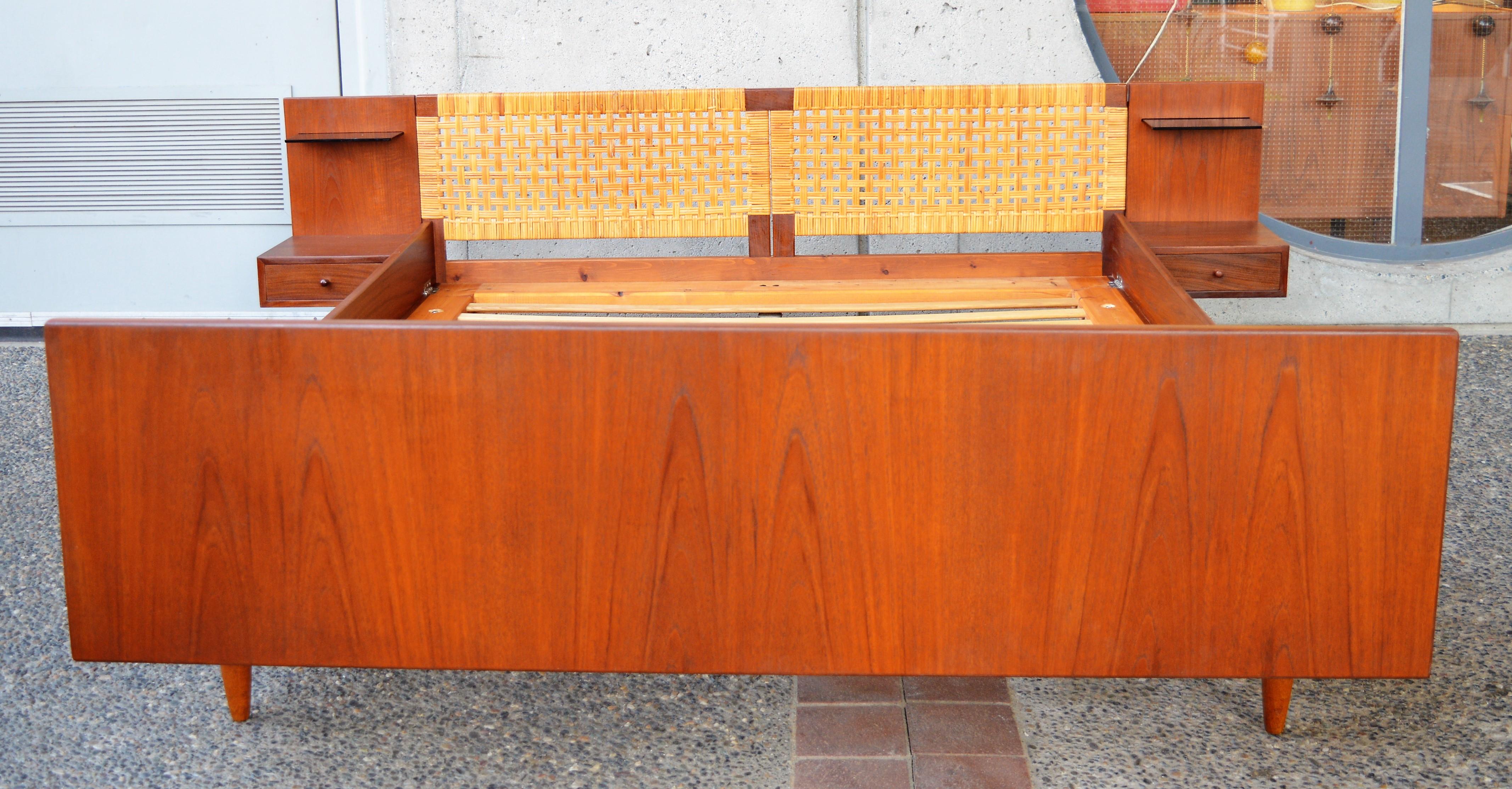 This rare and impeccable Danish modern teak top quality all wood platform bed was designed by Hans Wegner for GETAMA in the 1950s. Featuring a beautifully caned headboard with a pair of floating side tables with one drawer with dovetail joints and a