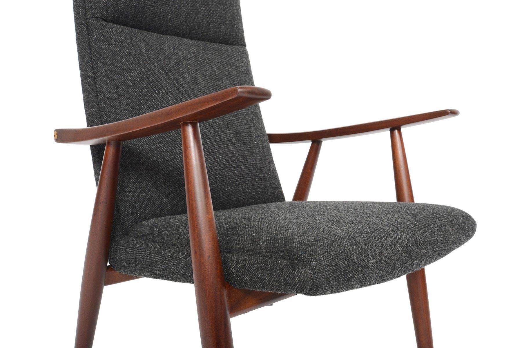 Model GE-260 was designed by Hans Wegner for GETAMA. Crafted in solid teak afrormosia, the ergonomic design of this chair is unparalleled. Large sculpted paddle arms show off the natural beauty of wood grain and are attached with the designer’s
